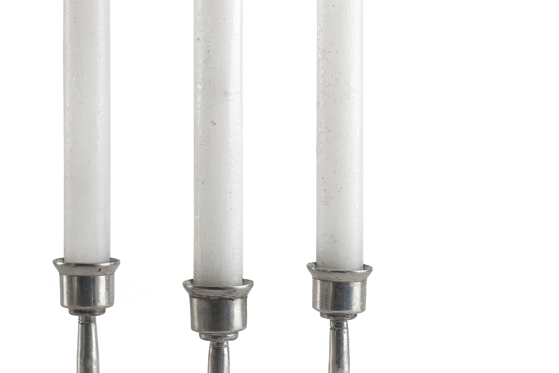 Close up of 3 white frosted Luma Afrika tapers to show the 'frosted' finish