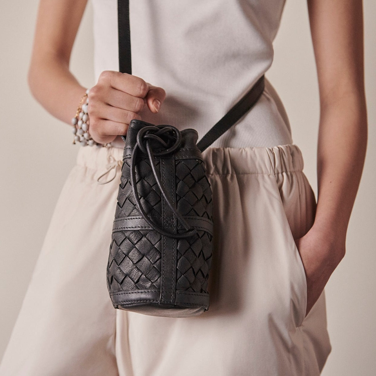 Mini essential bucket bag from womens bag collection in black showcasing interior view.