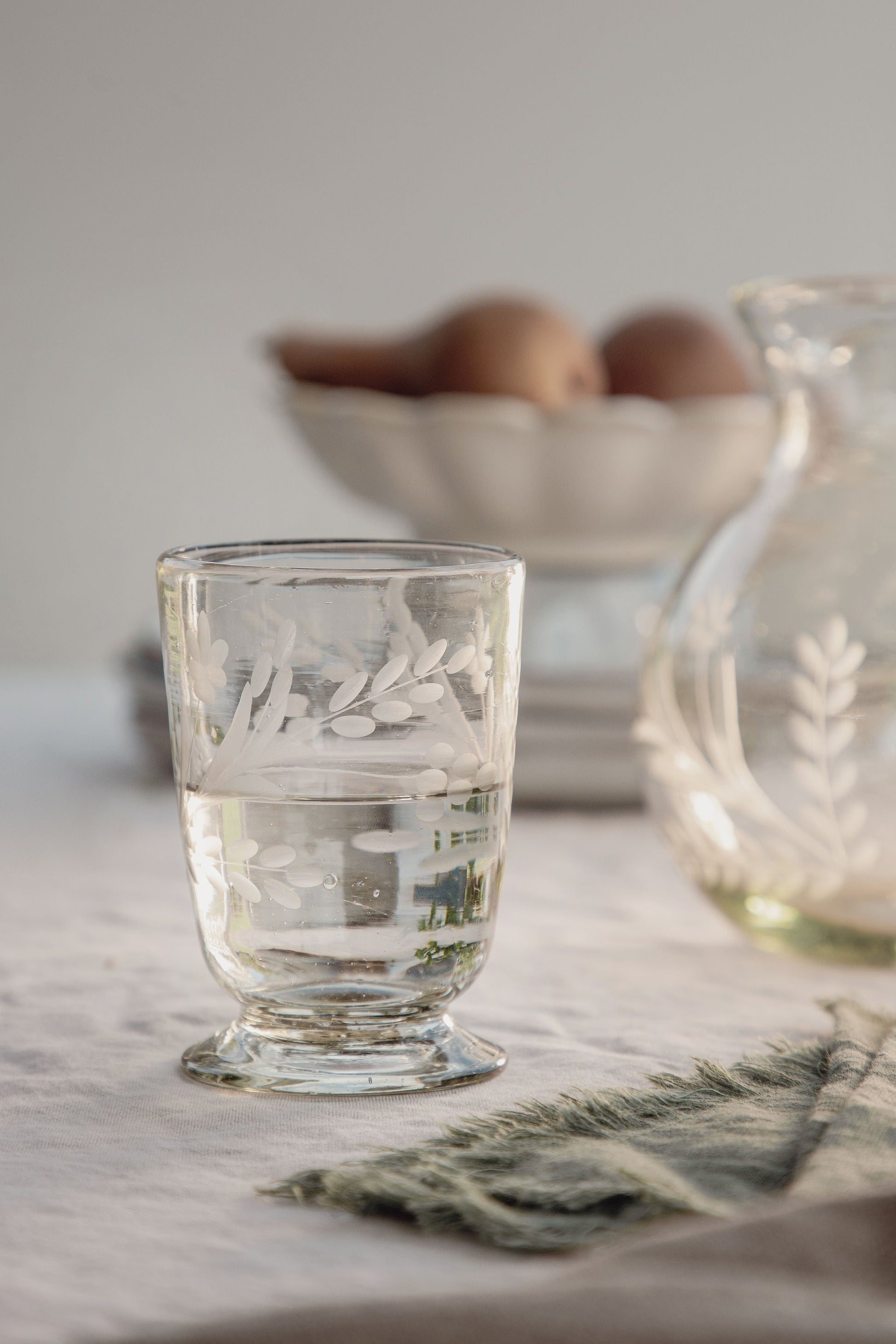 Handblown recycled glass footed vessel with hand-etched floral pattern