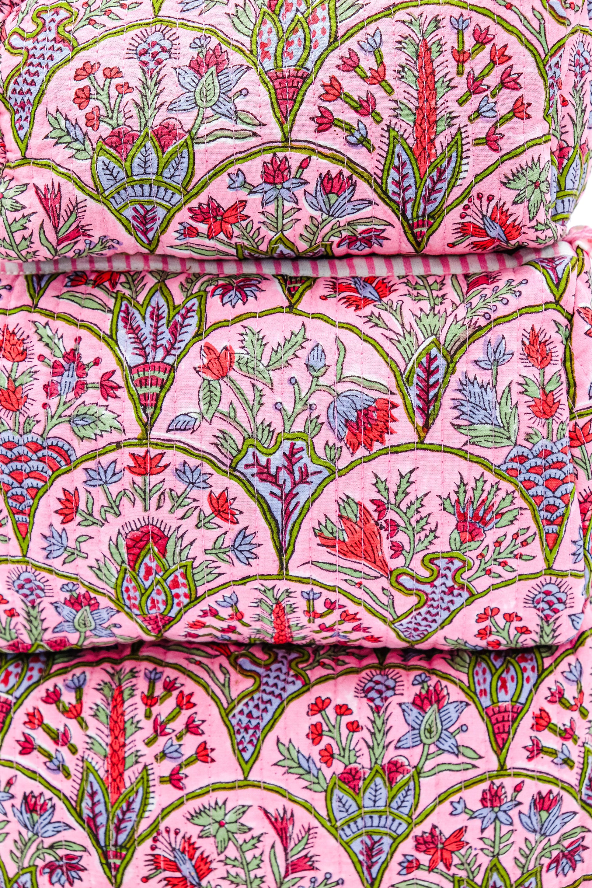 Close-up pink Arch toiletry bag fabric with floral patterns