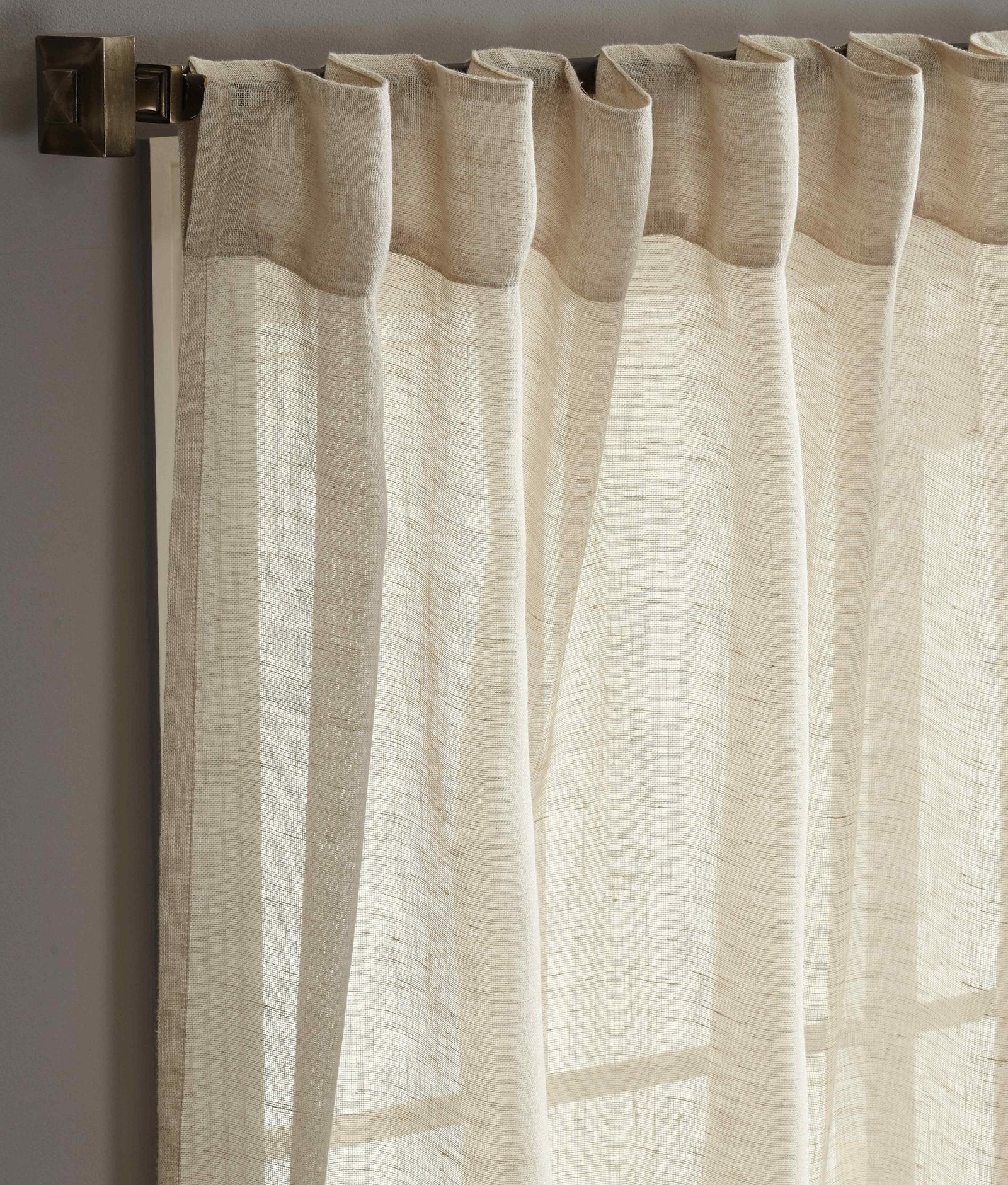 DY-709-5096_2|Close-up of beige linen tab top curtains, showing the textured fabric and simple, elegant hanging style. 