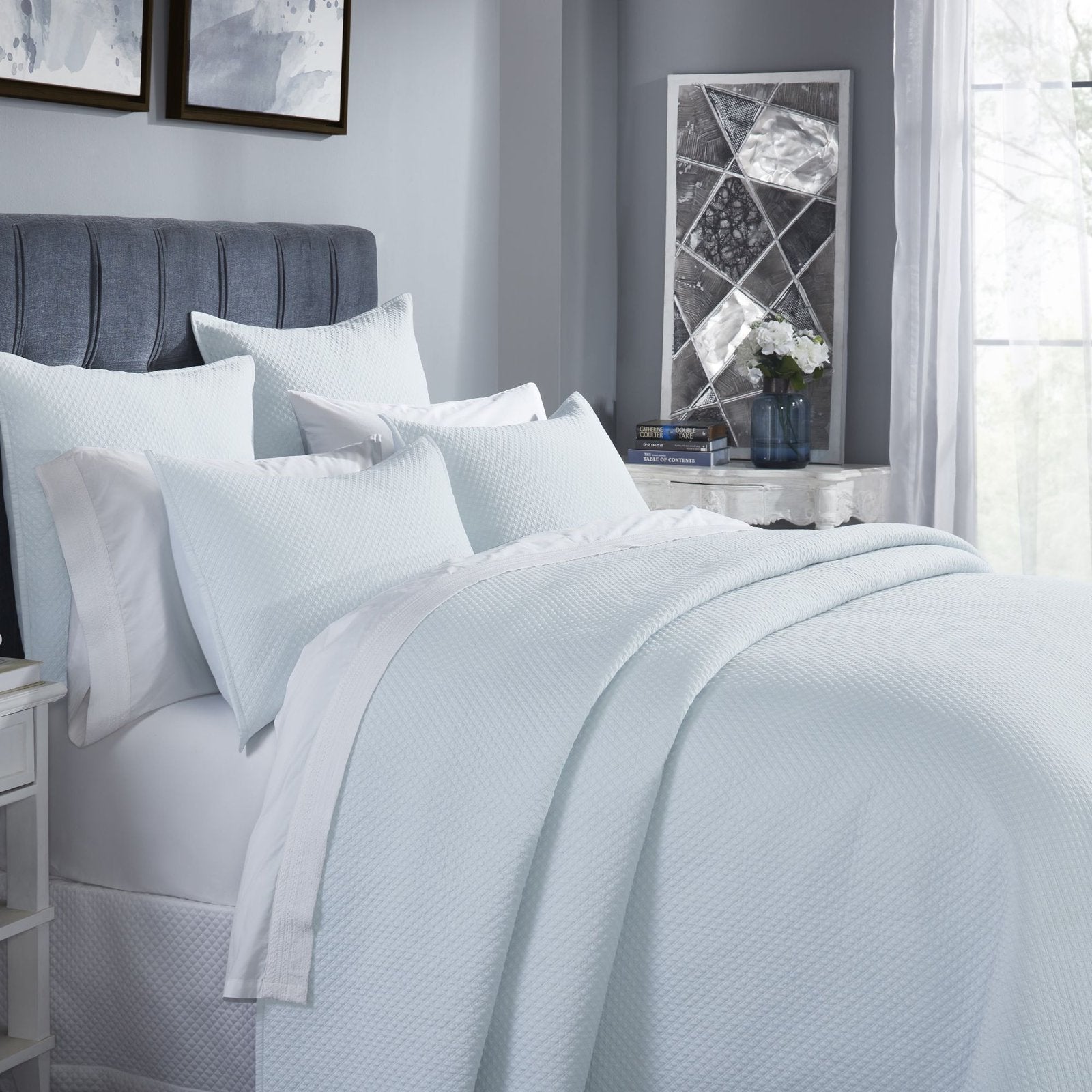 CL-251-9496_3|Close-up of a beautifully arranged light blue textured coverlet on a queen bed, showcasing its soft, inviting feel.