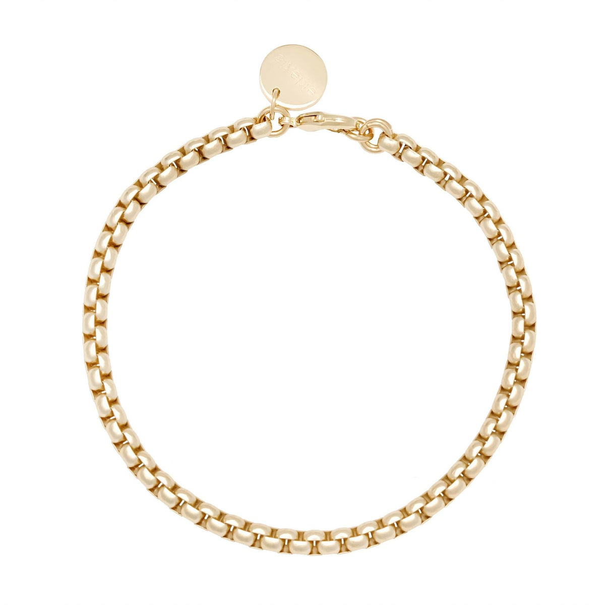 Gold-toned Luciana Box Chain Bracelet with round charm on display