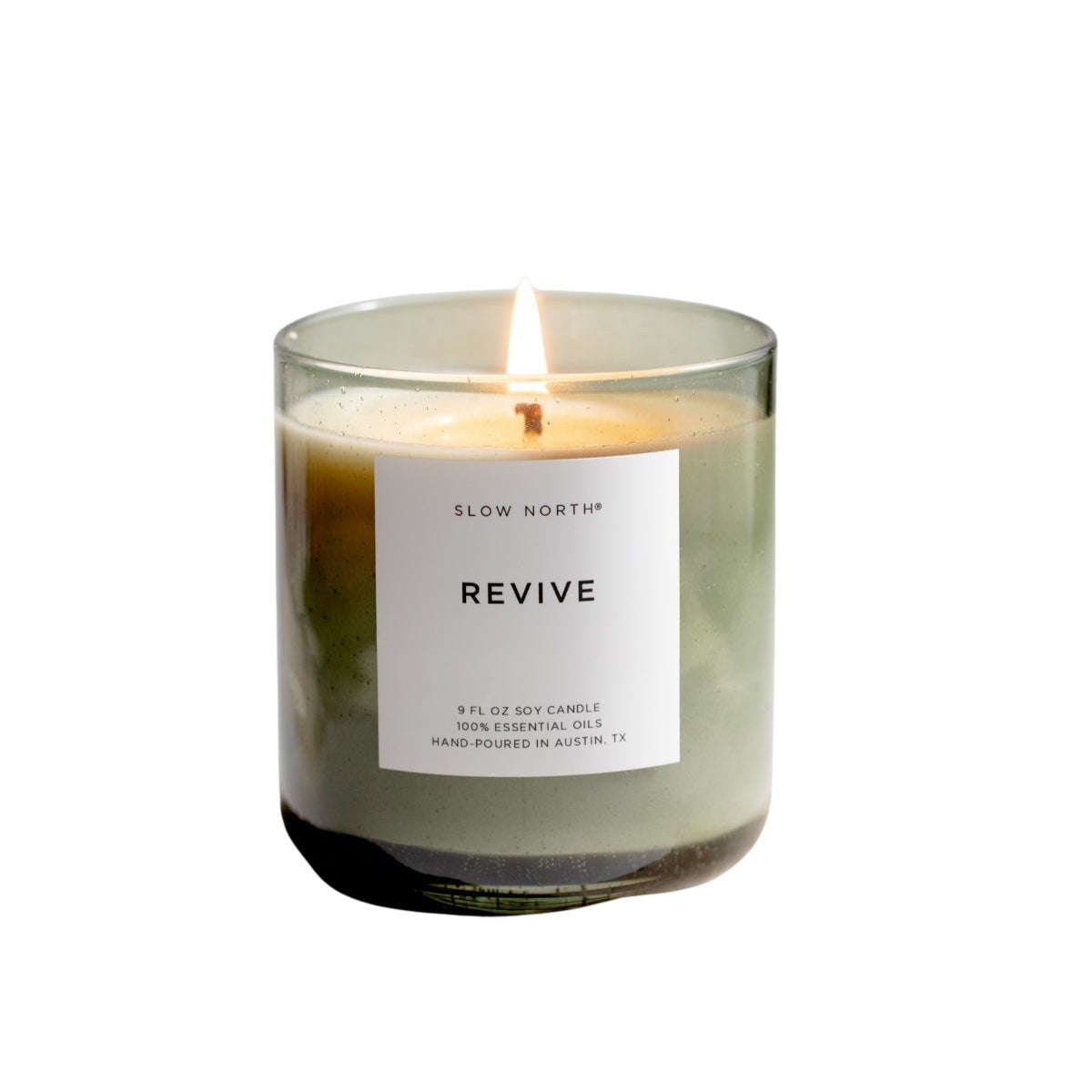 Candle labeled 'Revive' on a stone block with a white background