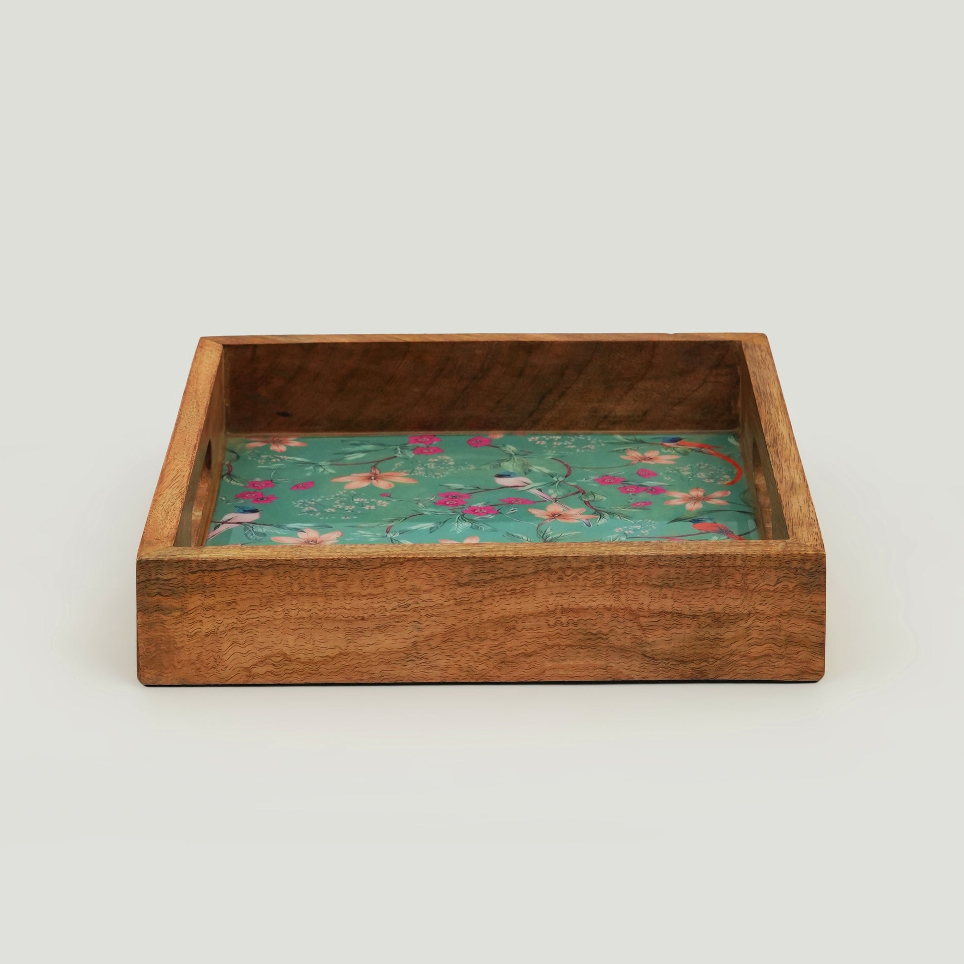 Detailed view of the intricate pink flower and bird motif against a turquoise enamel background.