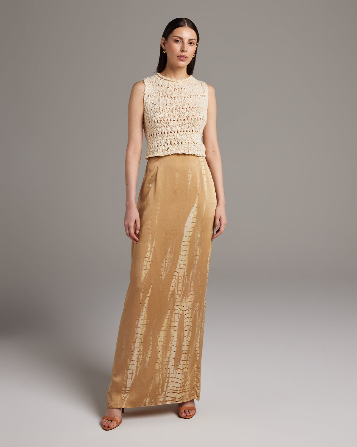 Model wearing a hand-knit Flammé Knit Crop Top with a long skirt