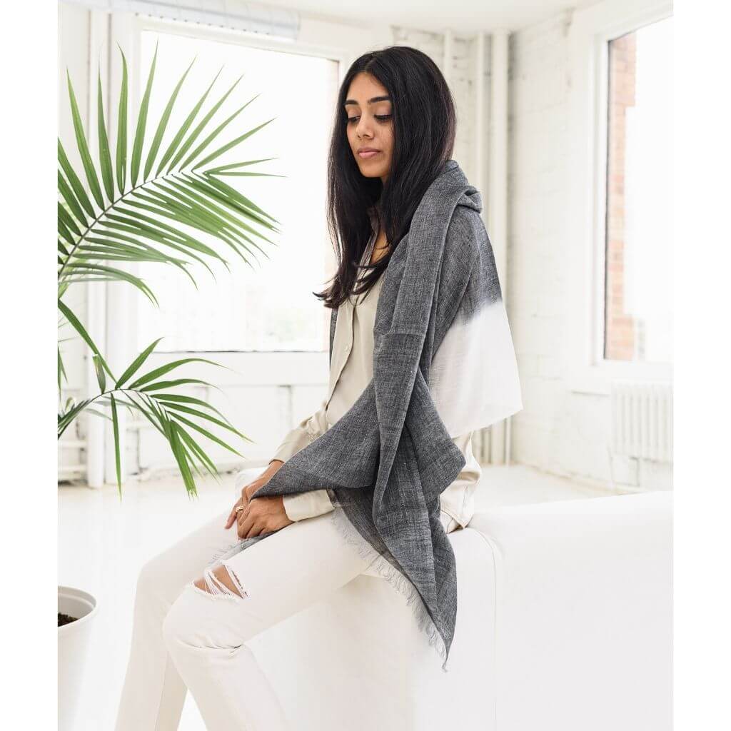 Granite Black White Ombre Linen Silk Handloom Scarf draped over a model in a stylish indoor setting.