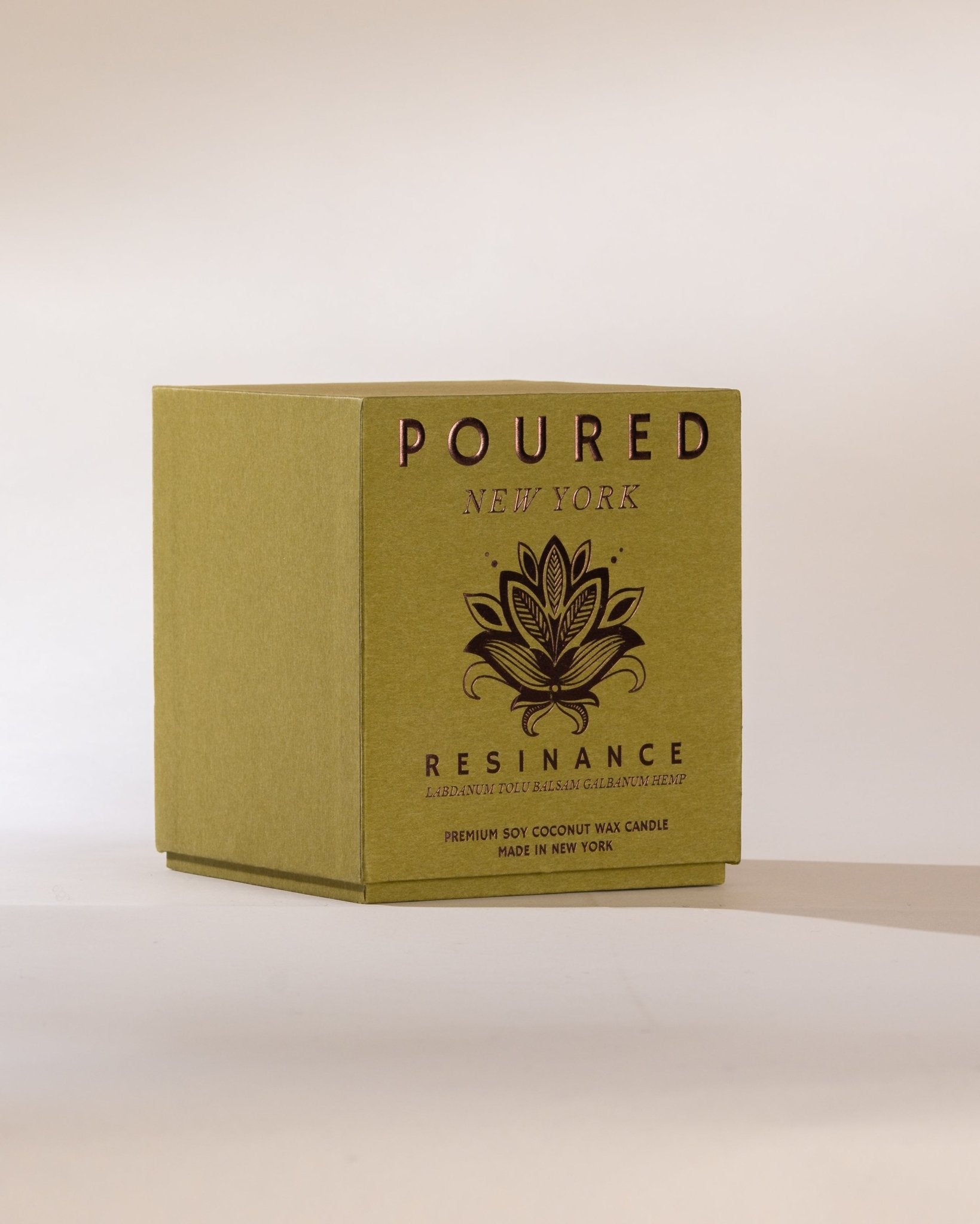 Poured New York 'Resinance' sage green candle box with floral decal on neutral background.