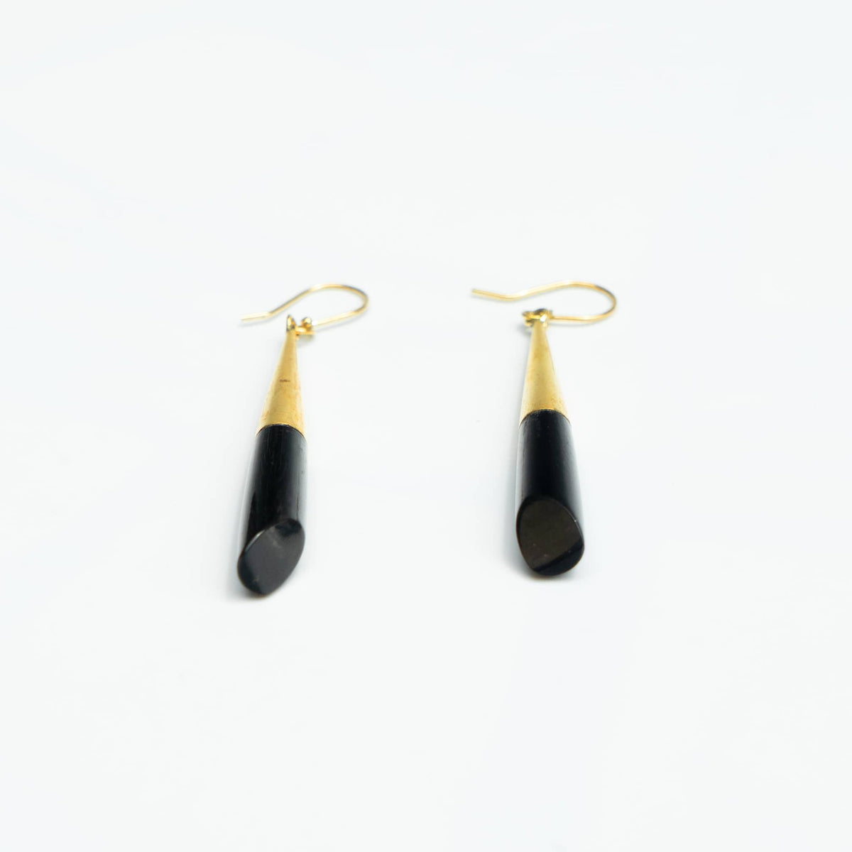 Shela black bone brass drop earrings worn showing material contrast