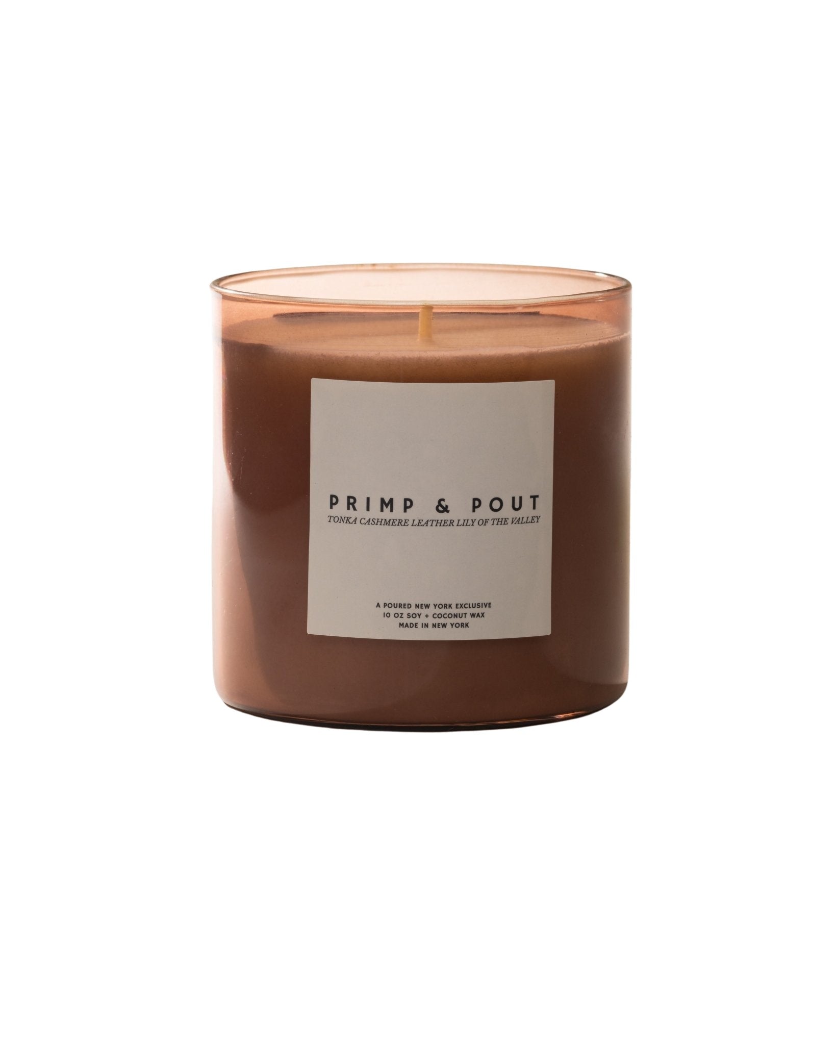 Candle labeled 'Primp & Pout' with a matching box with a pouty lip decal on a neutral background