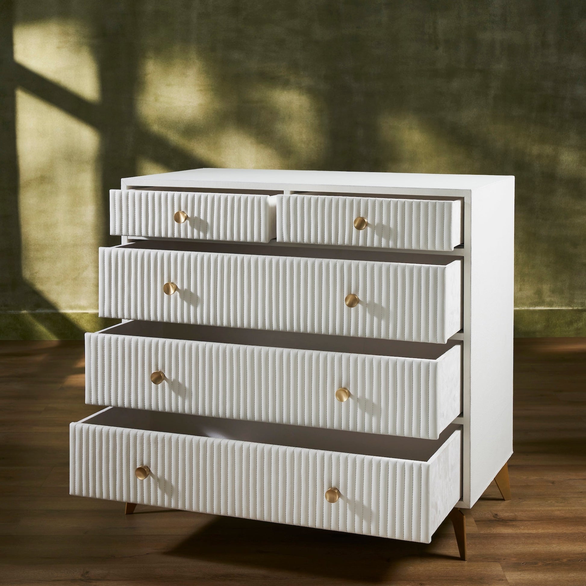 FN-5216-482036_3|Functional white ribbed leather dresser with multiple open drawers, revealing ample and stylish modern bedroom storage.