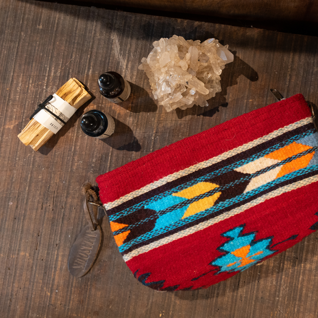 Handwoven convertible clutch with Zapotec pattern in bold colors; can be used as a pouch, wristlet, or crossbody with included leather straps and internal pocket.