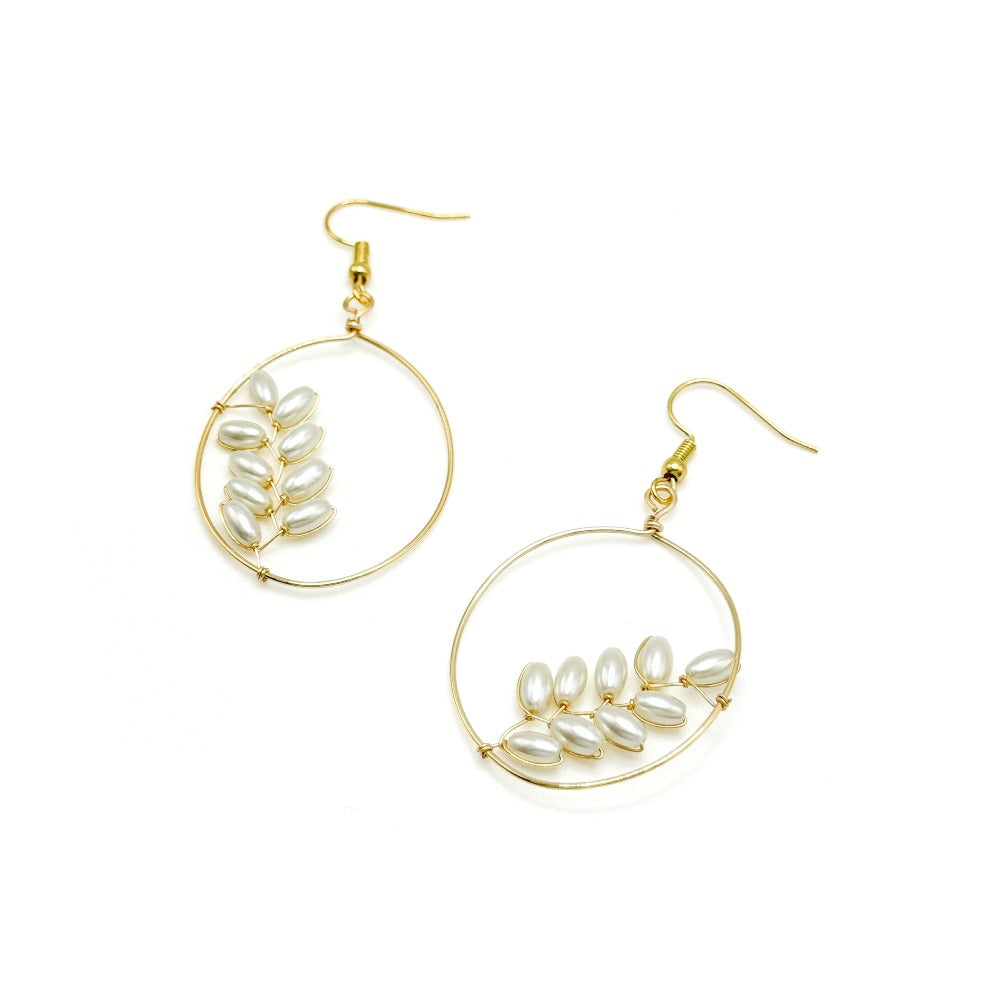 Pearl gold Artisan earrings modeled
