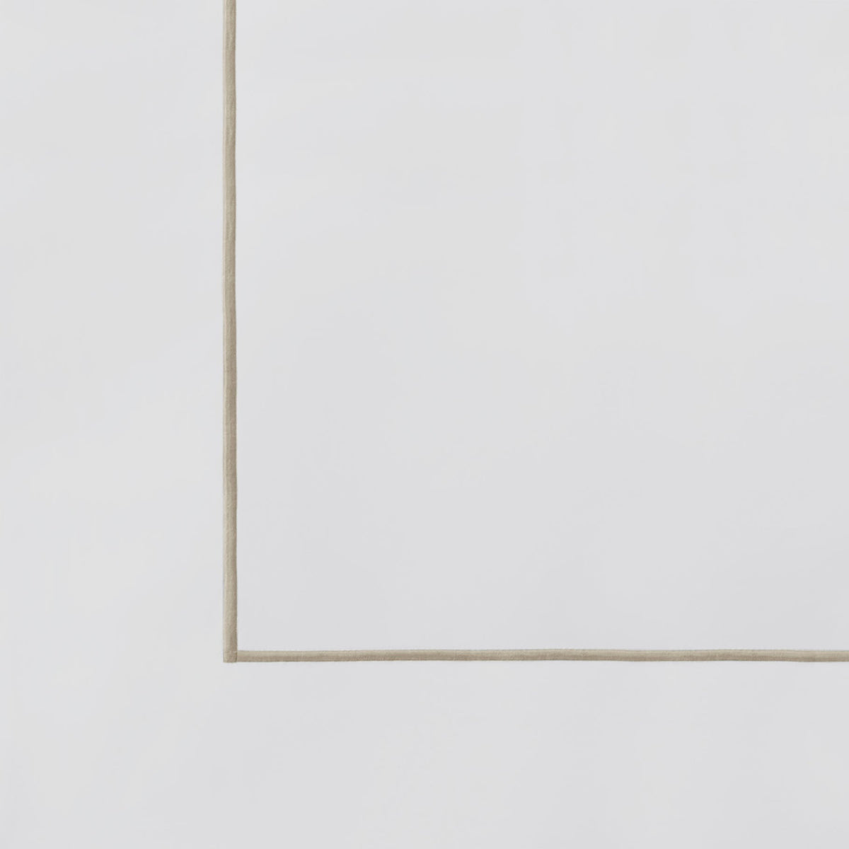 ASP-531-2032_6|Close-up view of a white 100% cotton flat sheet corner, showcasing a delicate tan piped border detail.