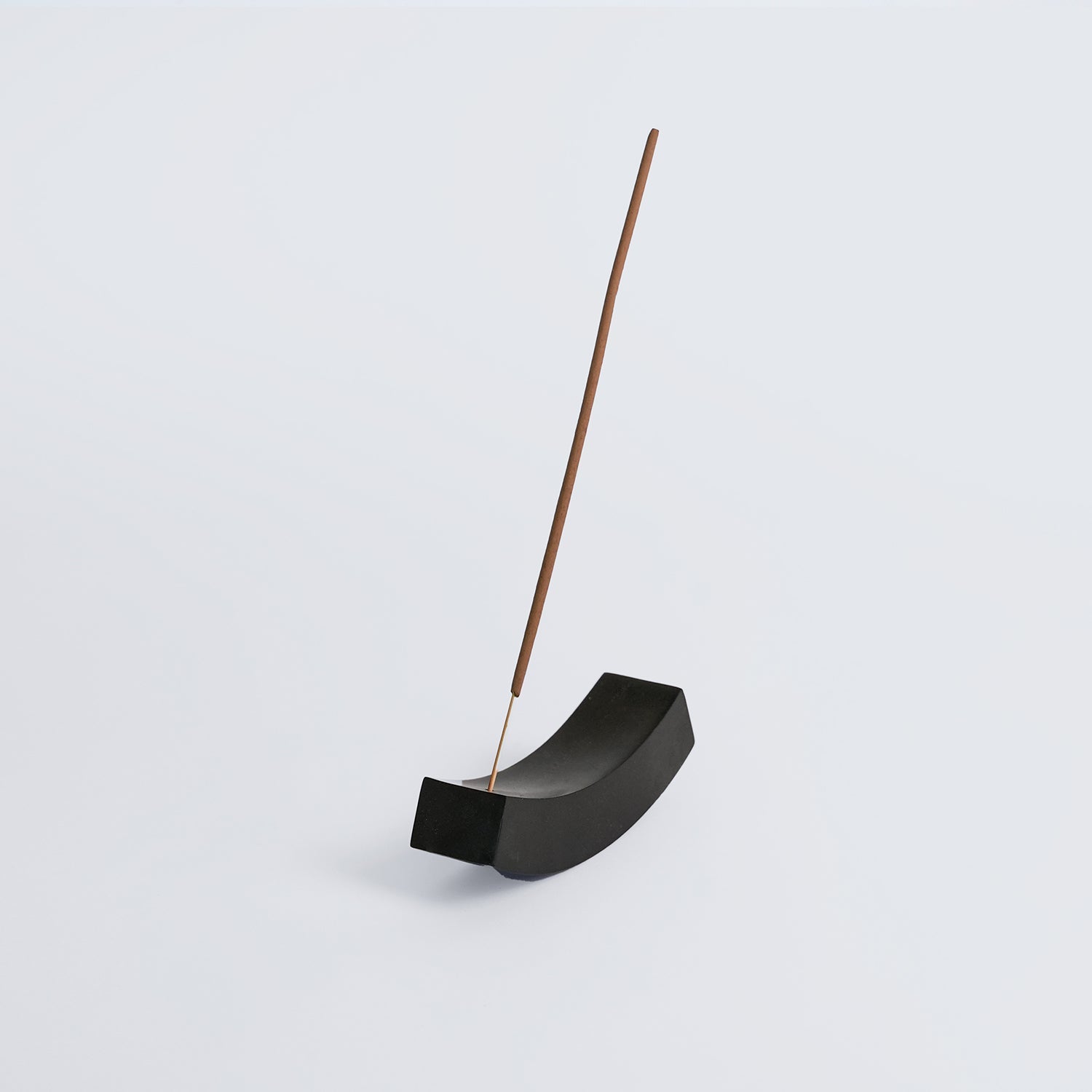 Black onyx smile gemstone incense holder with a sleek, minimalist design on a white background.