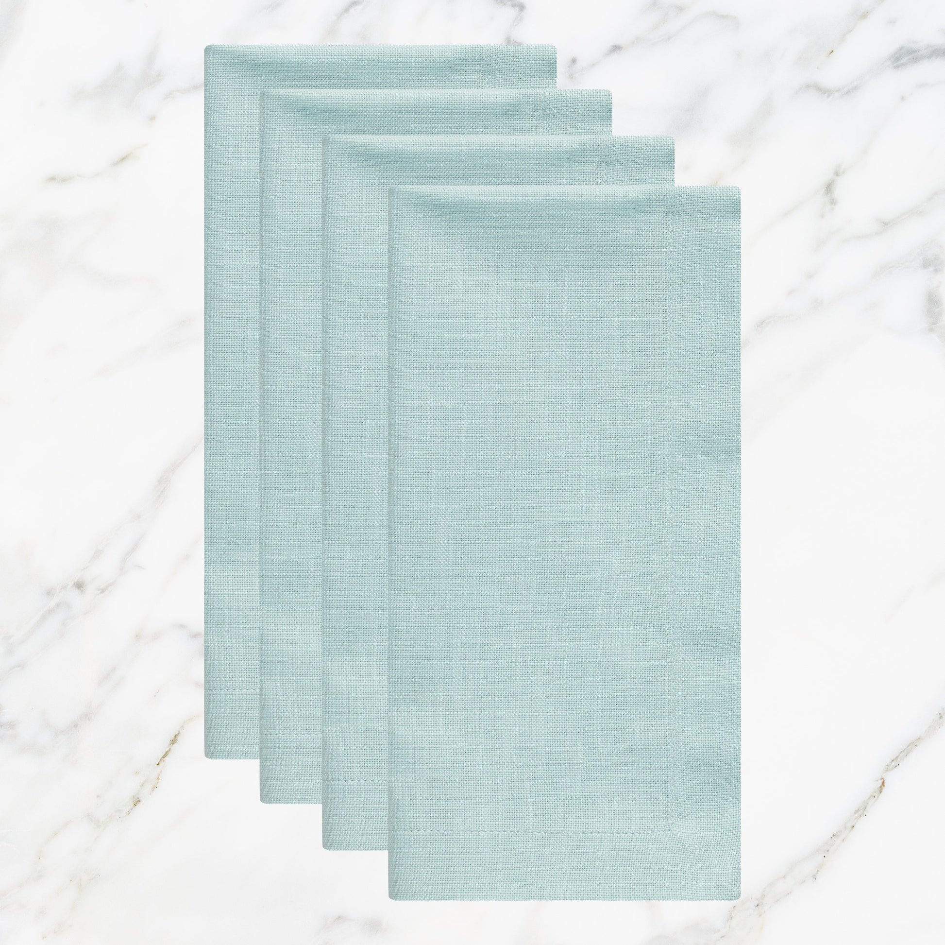 NP-4803-2020_1|Set of four folded aqua blue linen-blend napkins on marble. Stylish reusable cloth for weddings, parties, and daily meals.