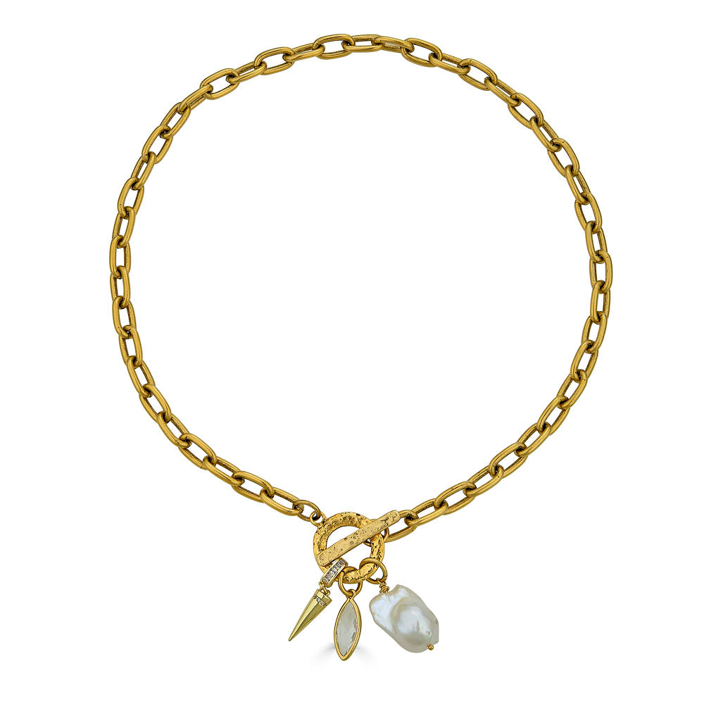 Gold chain necklace with toggle clasp, featuring a baroque pearl, marquise-cut crystal, and gold spike charm
