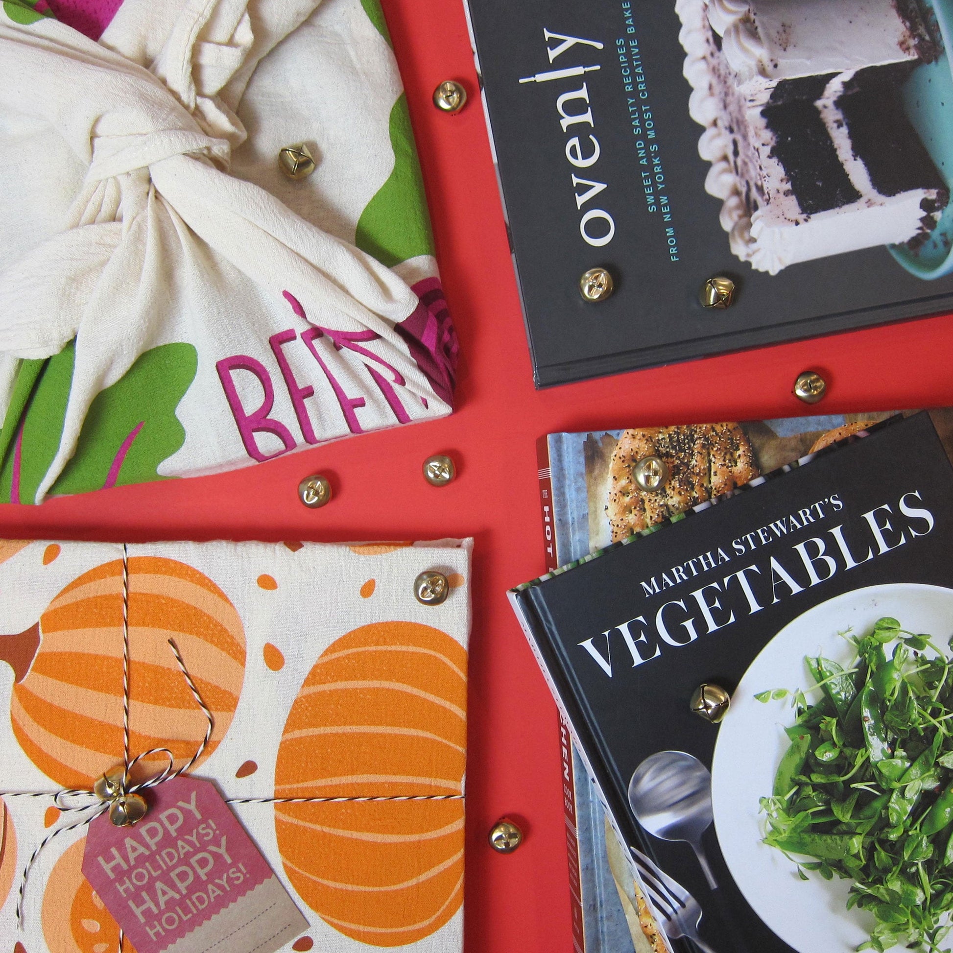 Beet dish towel photographed alongside cookbooks
