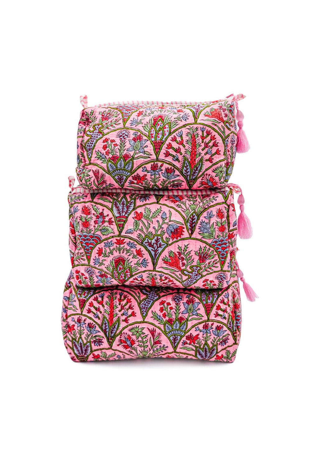 Stack of pink Arch toiletry bags with floral blockprint design