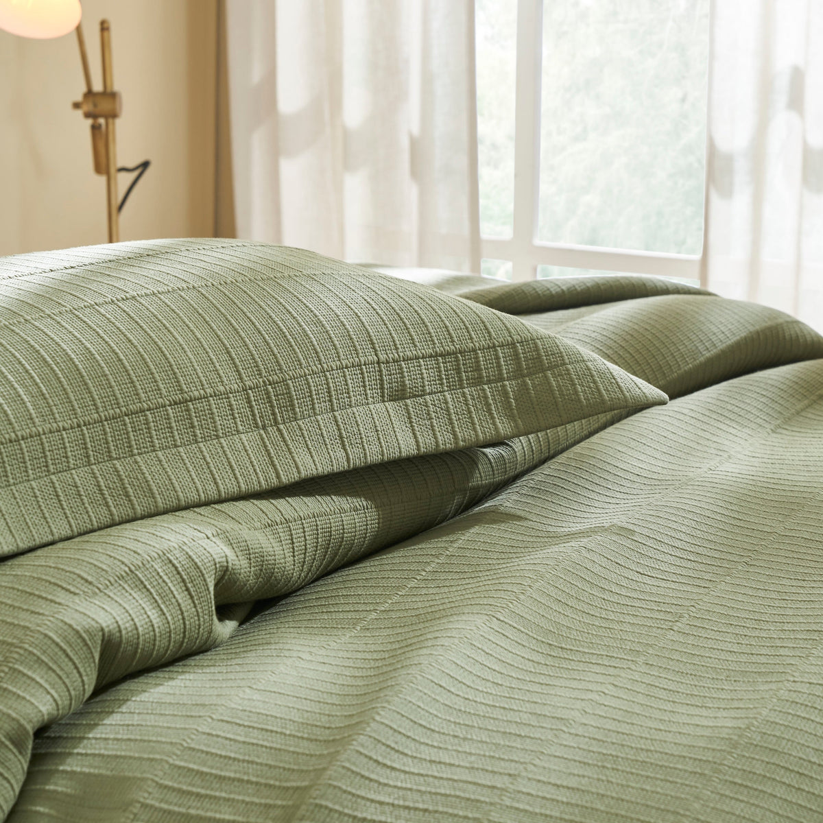 KS-270-2036_3|Inviting olive green textured coverlet and matching ribbed pillow shams, creating a serene and comfortable bedroom ambiance.