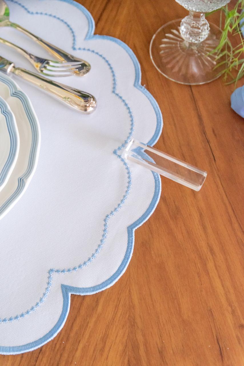 The blue Victoria impermeable placemat with Victorian-style border detail by Talah Home