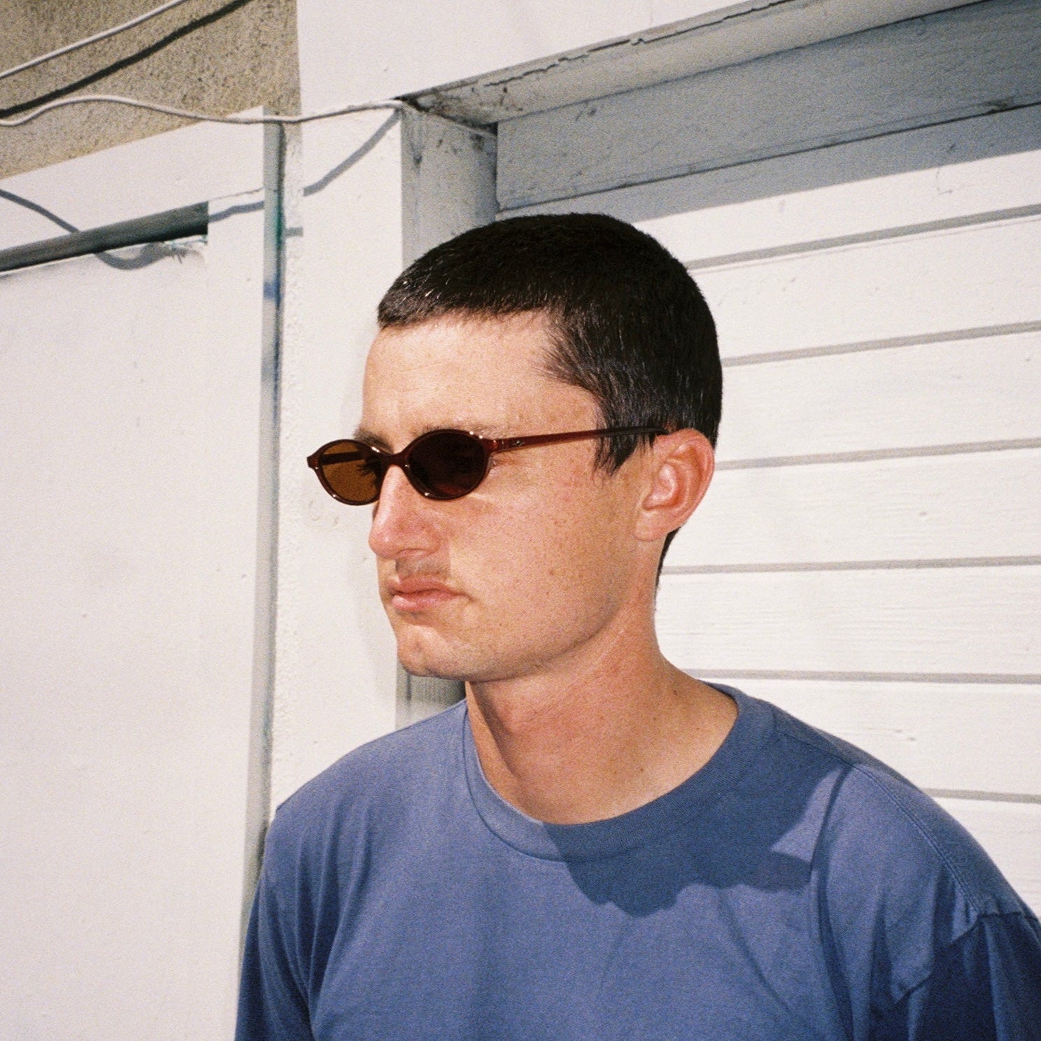 Zachary Kovacs wearing SAD Eyewear Celeste oval sunglasses in tobacco with polarized bronze UV protection lenses
