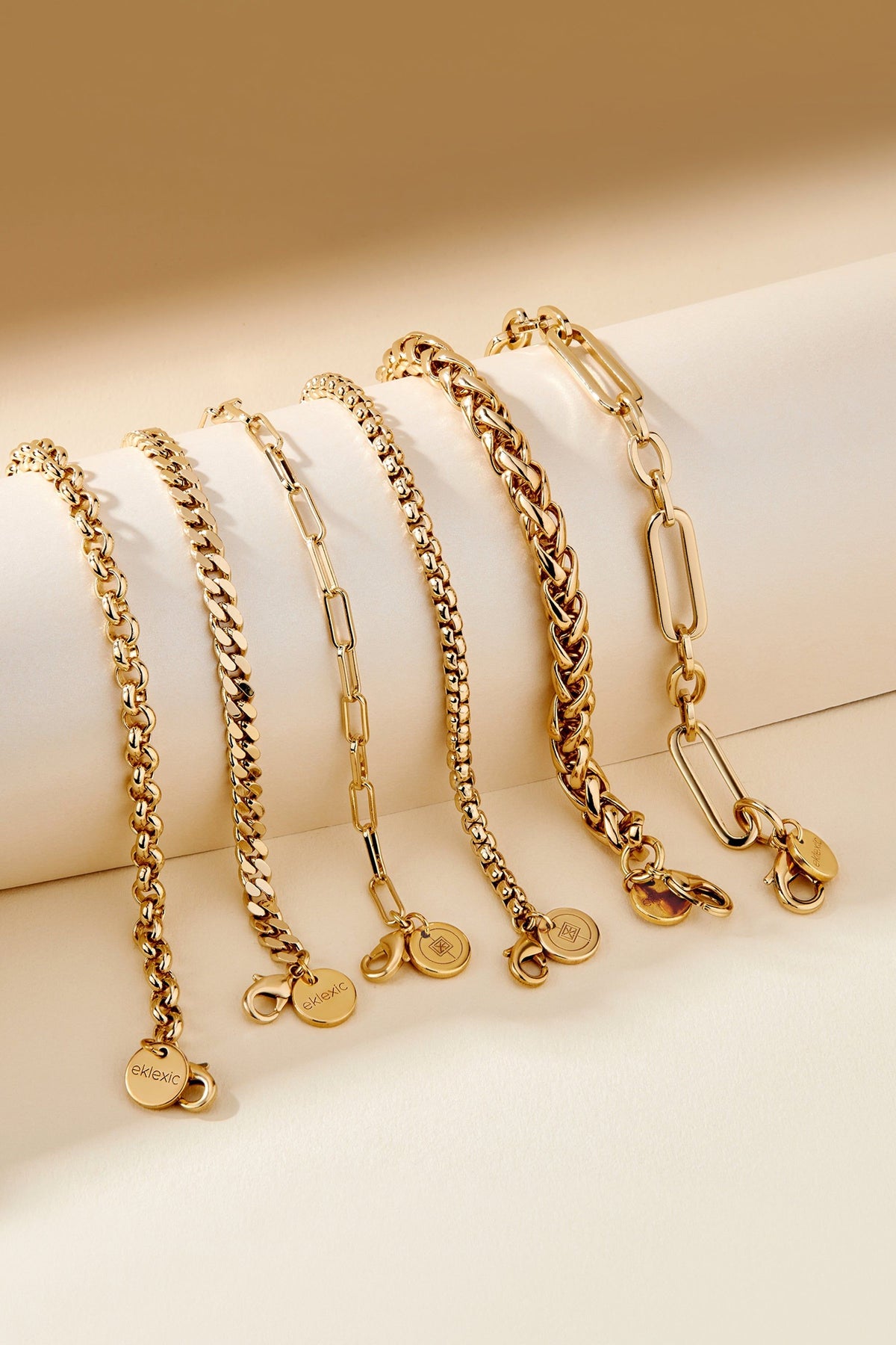 Gold-tone chain bracelets with coin charms from the Esmé Bracelet collection