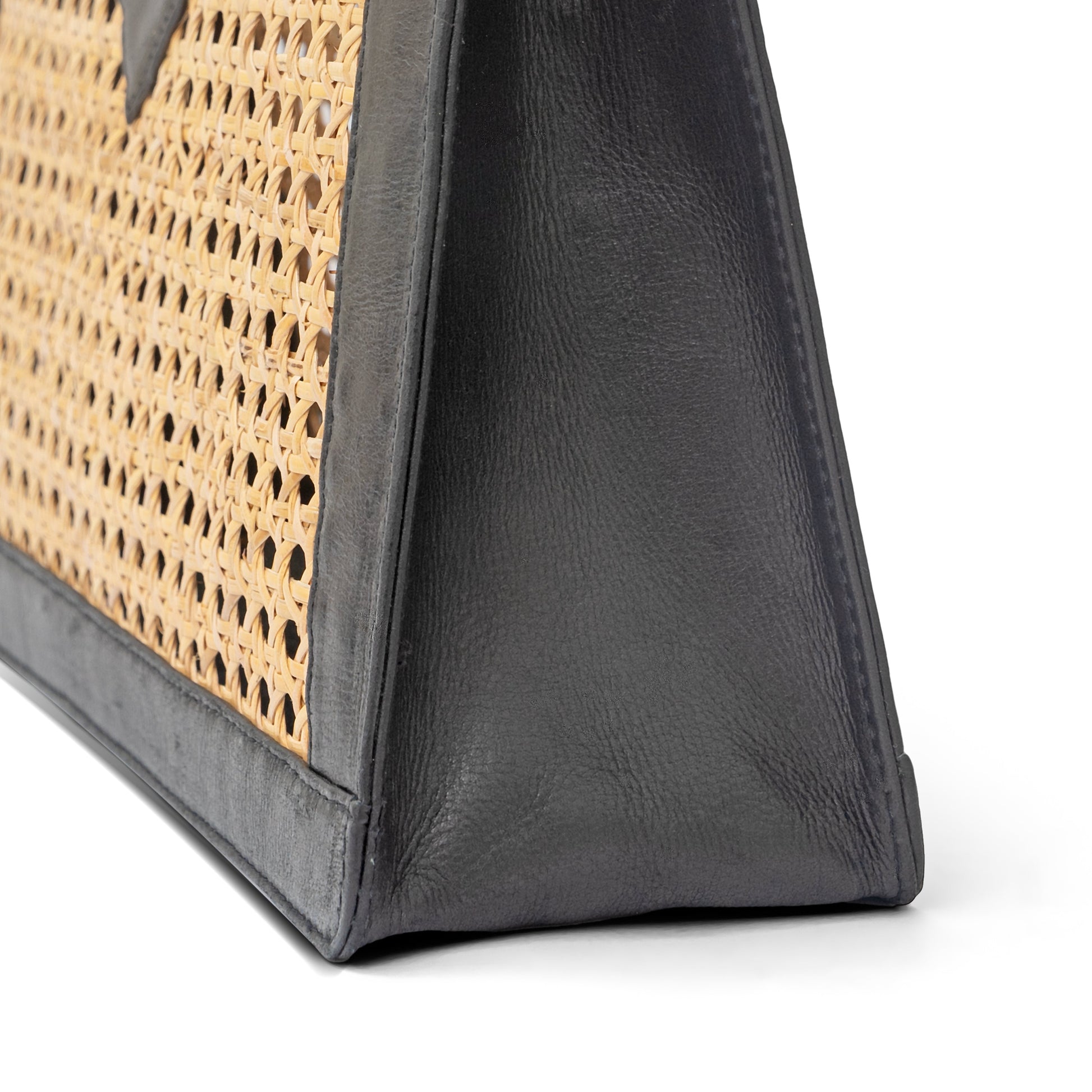 Detail view black leather trim and open weave rattan cane webbing top handle tote basket handbag