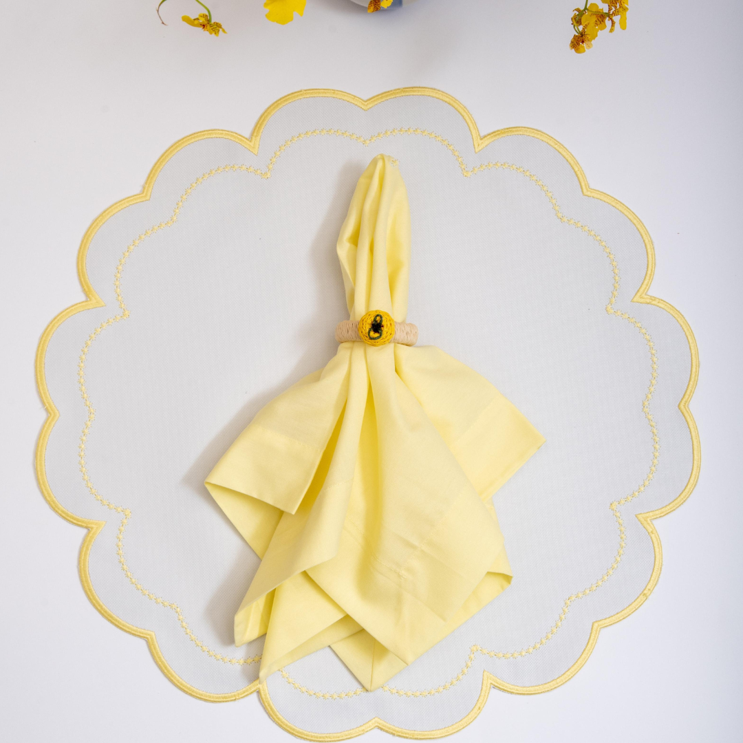 The yellow Victoria impermeable placemat with Victorian-style border detail by Talah Home