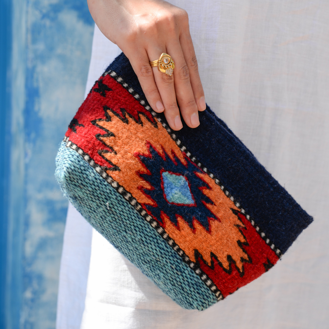 Handwoven pouch with abstract Zapotec arrow design in bold colors featuring internal pocket; perfect for makeup, wallet, or daily essentials.
