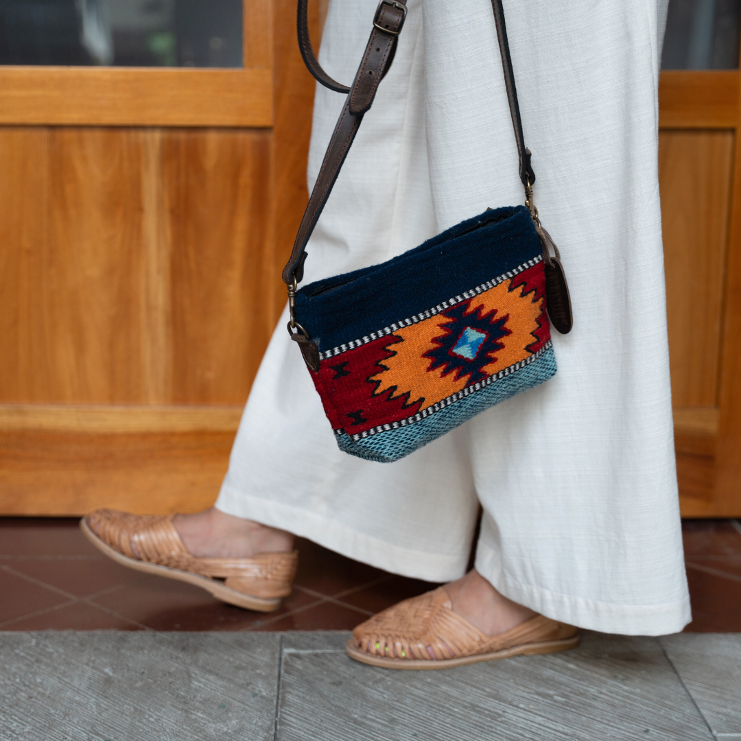 Handwoven convertible clutch with Zapotec pattern in bold colors; can be used as a pouch, wristlet, or crossbody with included leather straps and internal pocket.