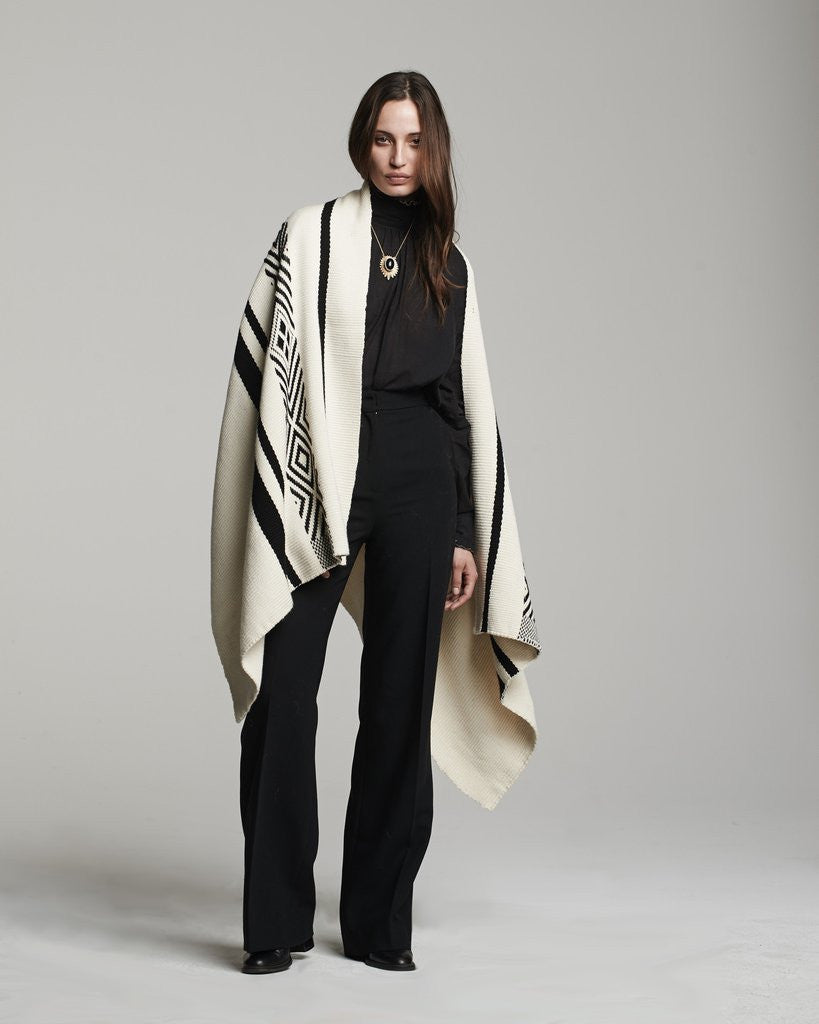 Model wearing a Comunidad Wrap with geometric patterns in black and white