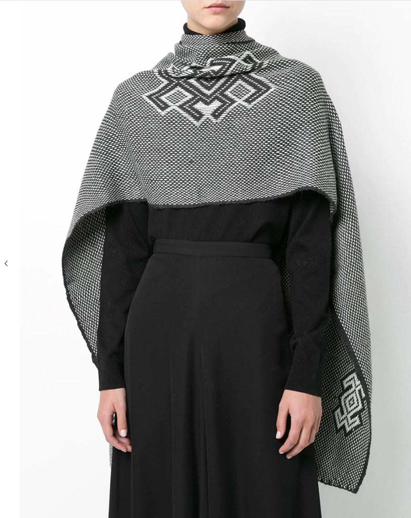 Model wearing Araña Shawl in Charcoal/Ivory with geometric pattern