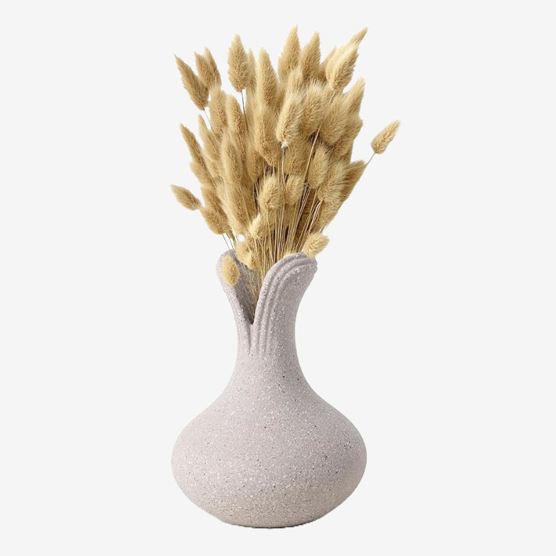 A beige recycled clay ceramic vase with a textured finish, displaying a bundle of dried plants.