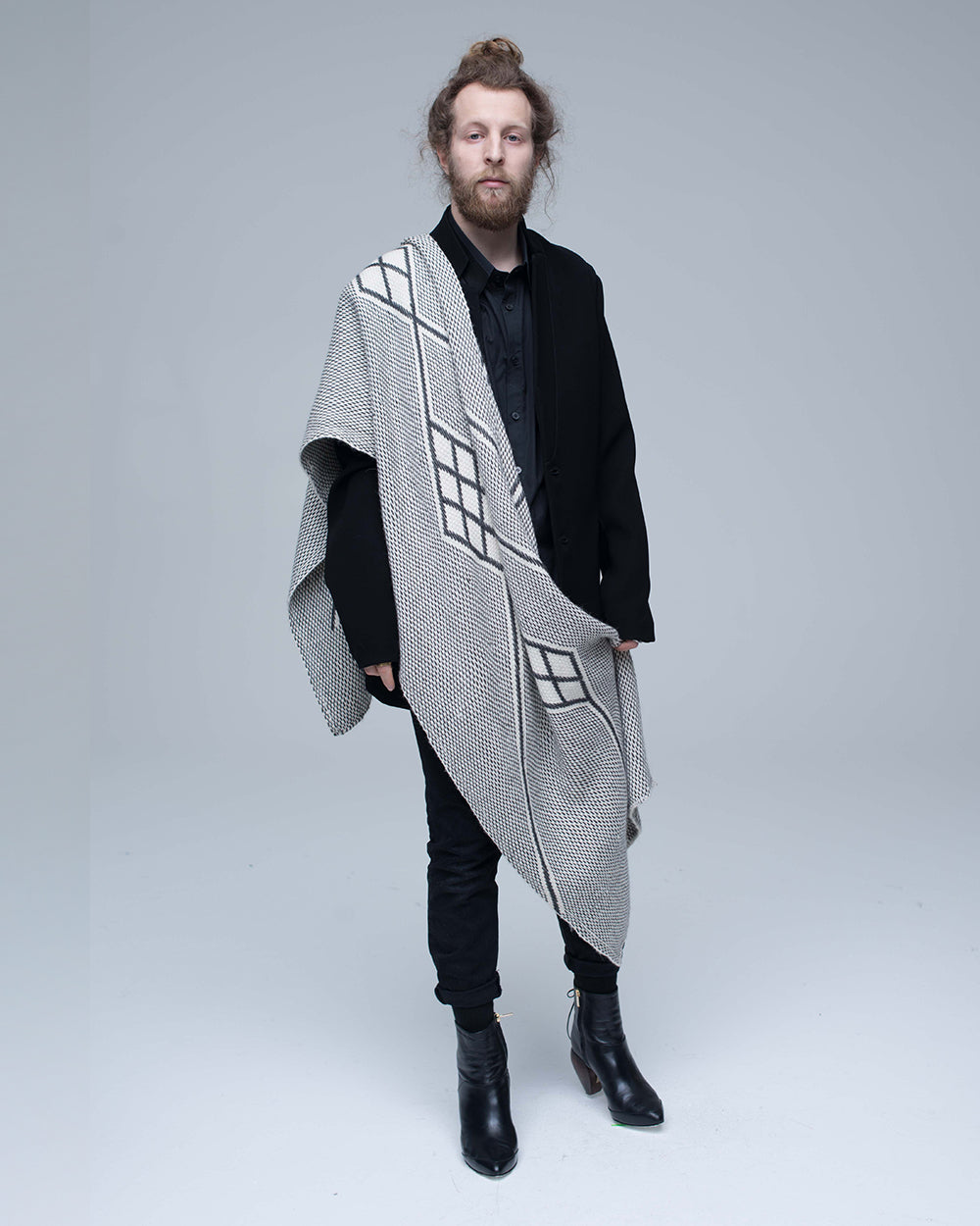 Model wearing Che Shawl in Baby Alpaca with geometric patterns