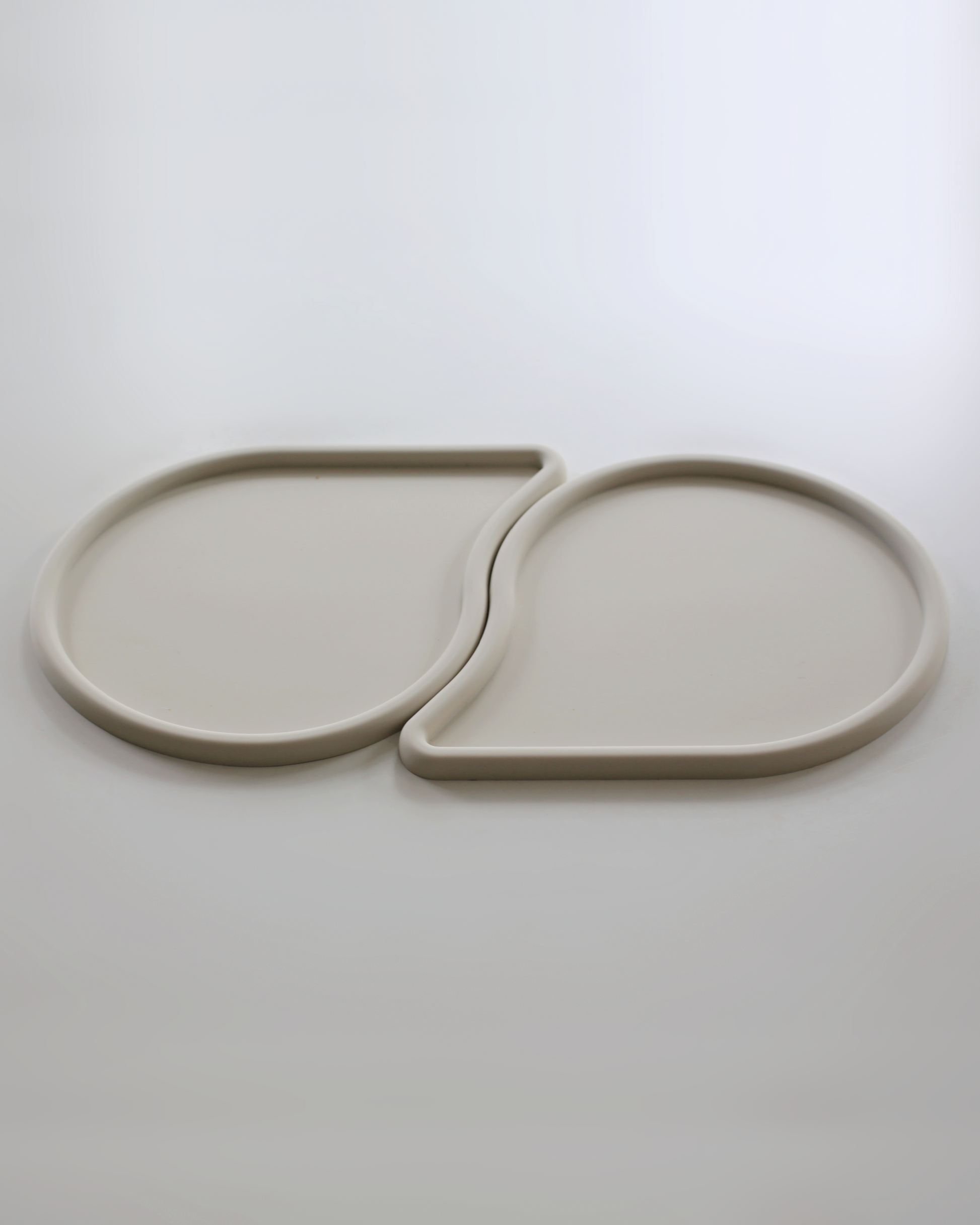 two raindrop shaped pet feeding mats by catenary home modern cat furniture company that can be used as a cat food mat and dog food mat or pet meal mat that fit into each other 