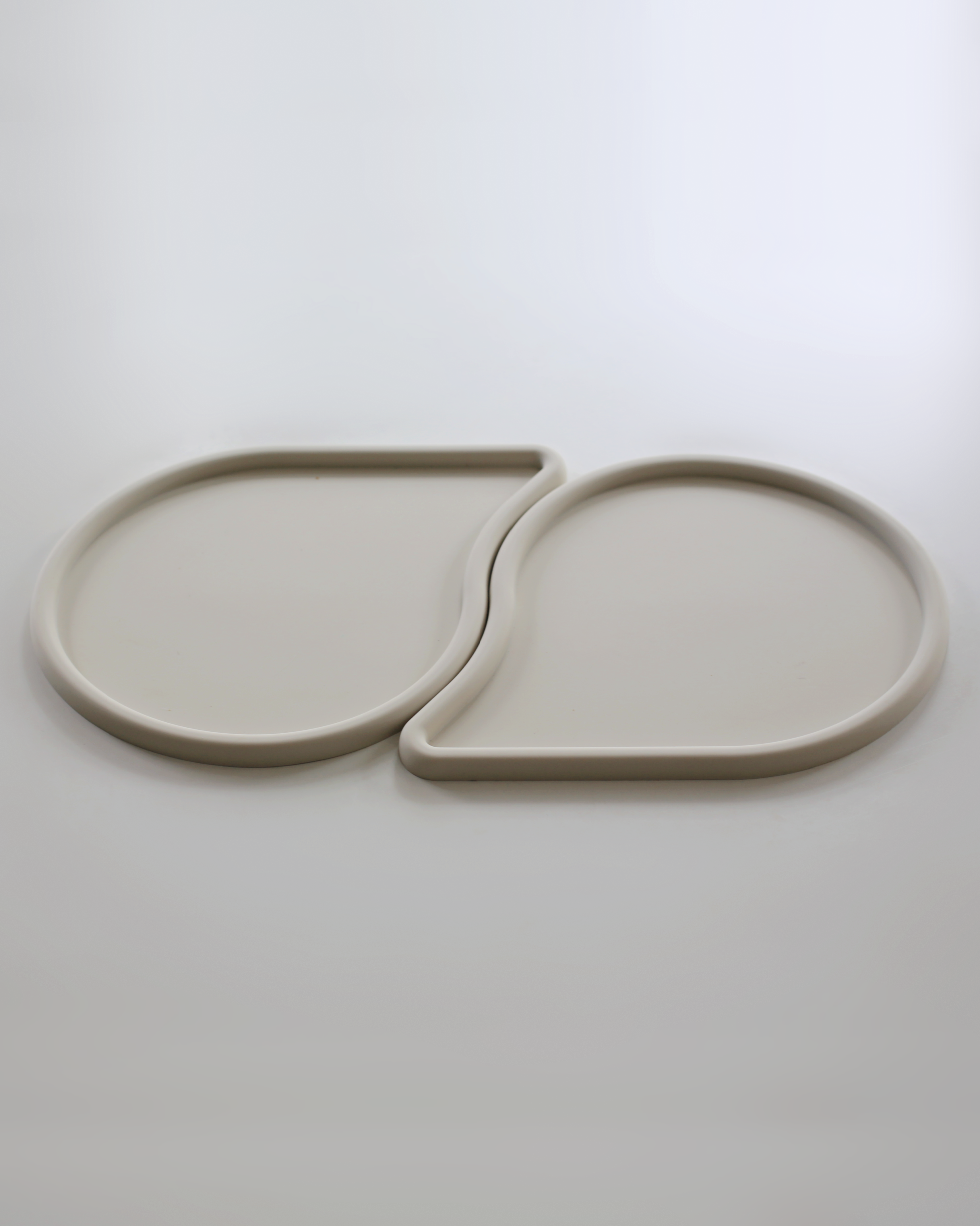 two raindrop shaped pet feeding mats by catenary home modern cat furniture company that can be used as a cat food mat and dog food mat or pet meal mat that fit into each other 