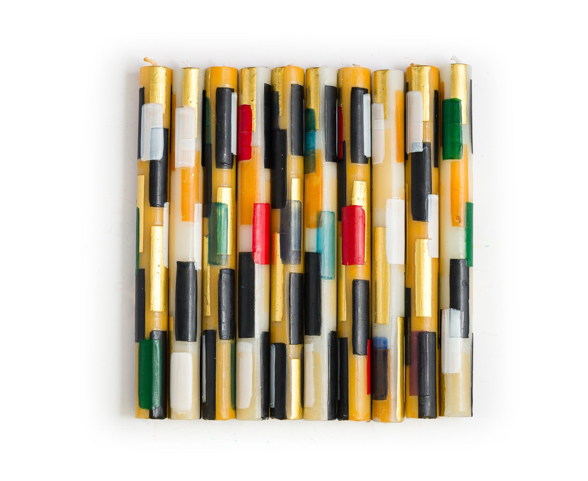 10 Klimt tapers one in each design of the collection.  Cream & gold color tapers with rectangles of color; black, white, gold, consistent on all, then highlights of green, red, turquoise, dark blue, and forest green.