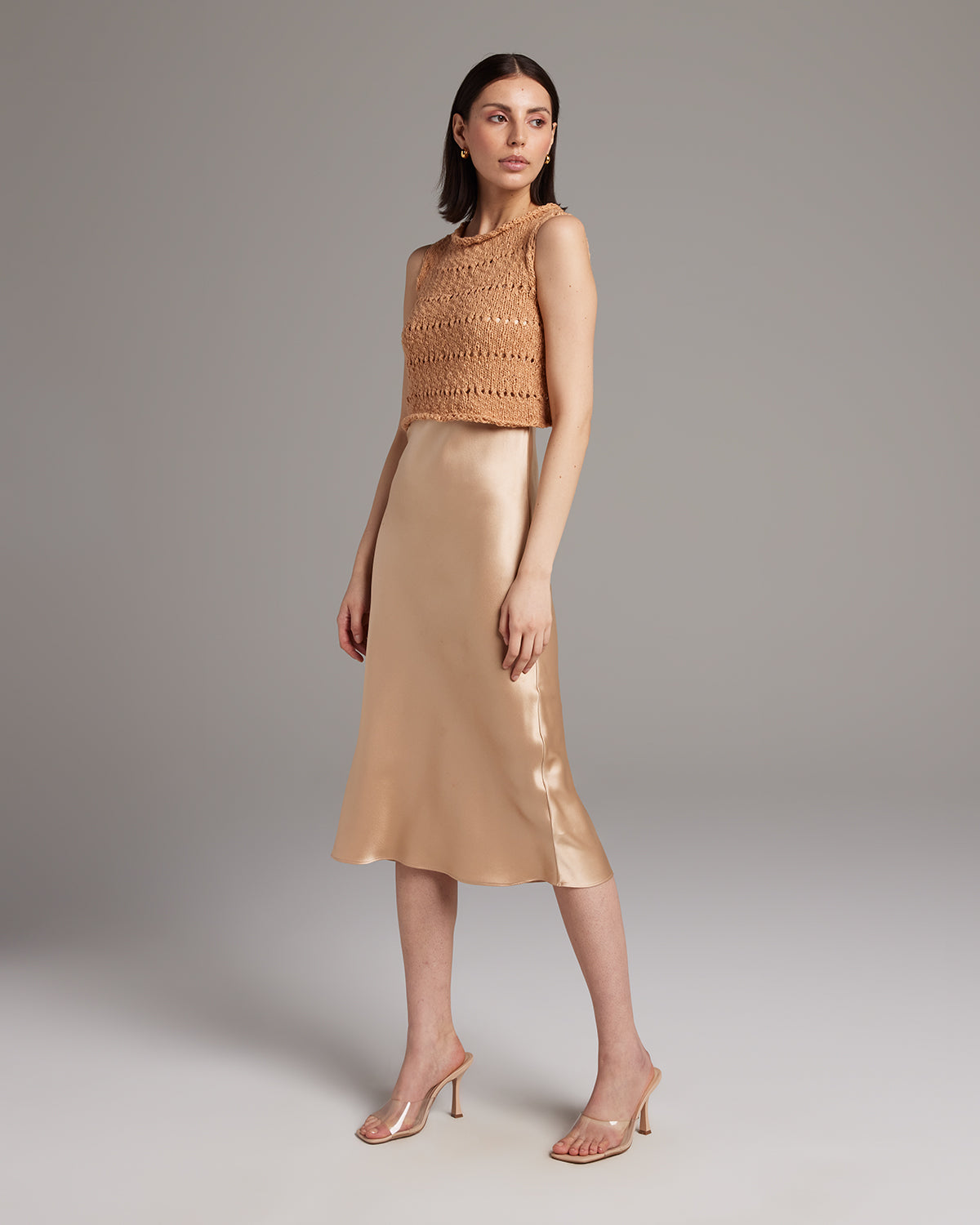 Model wearing a Flammé Knit Crop Top with a satin skirt
