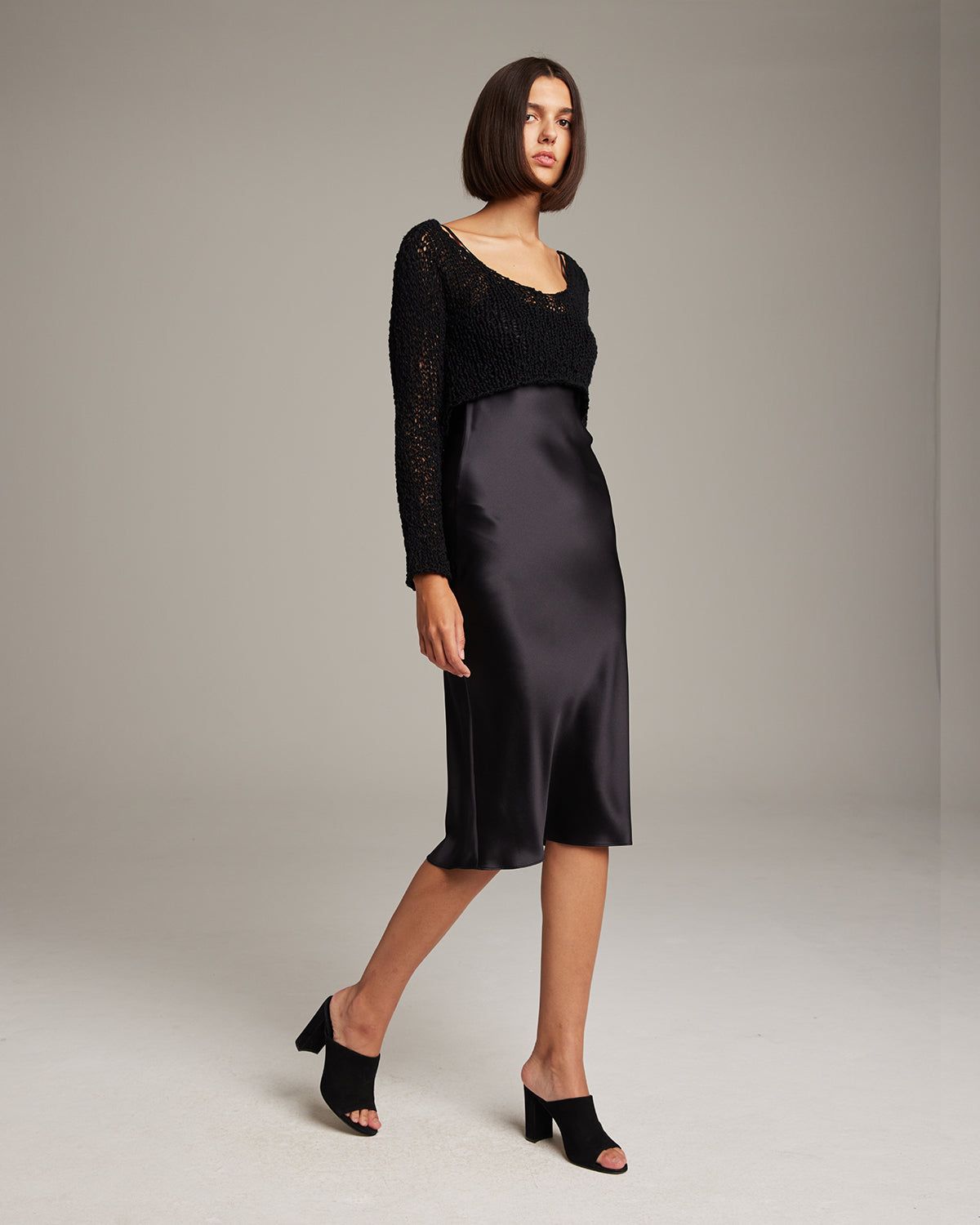 Black Flammé Loose Knit Cropped Sweater with asymmetrical hemline