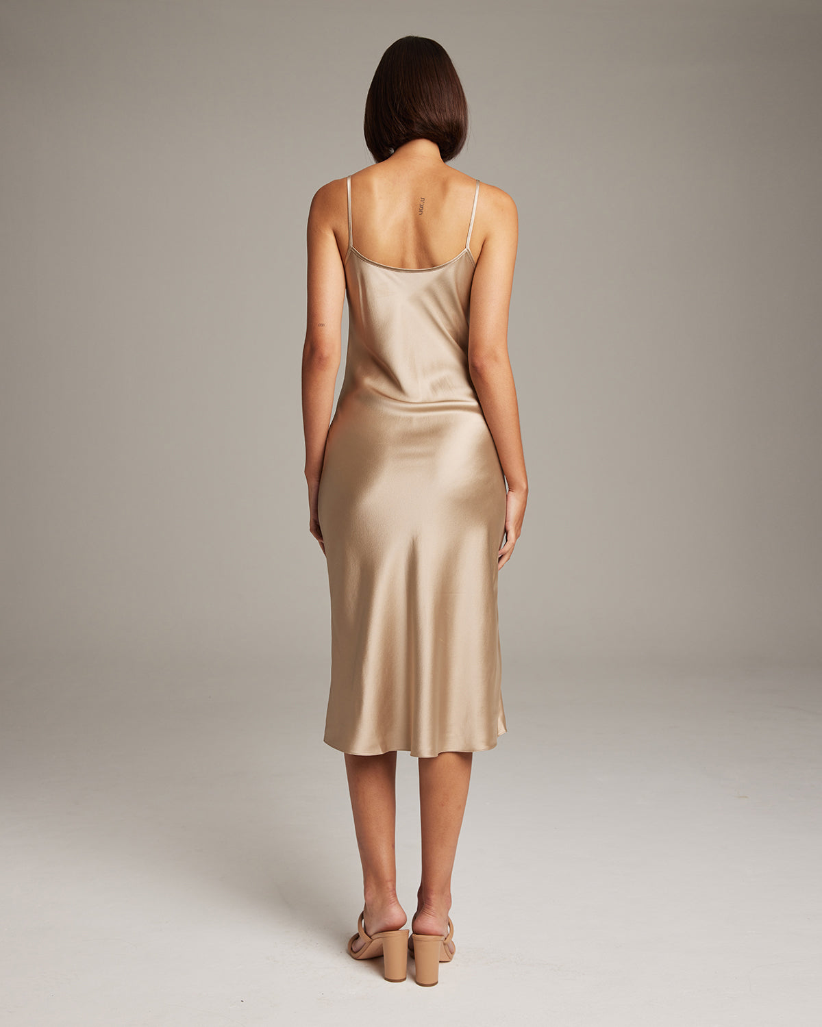 Back view of champagne-colored VOZ MIDI SLIP DRESS