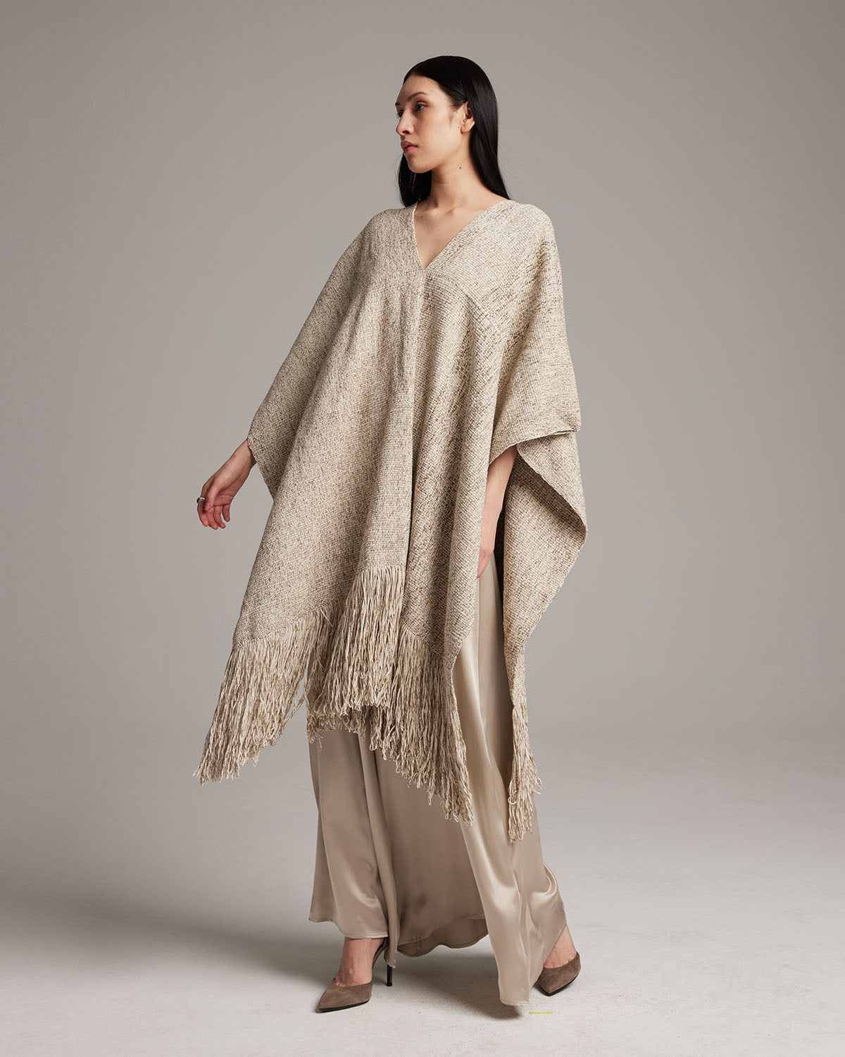Model wearing a long, sand-colored Marble Fringe Manta with fringes