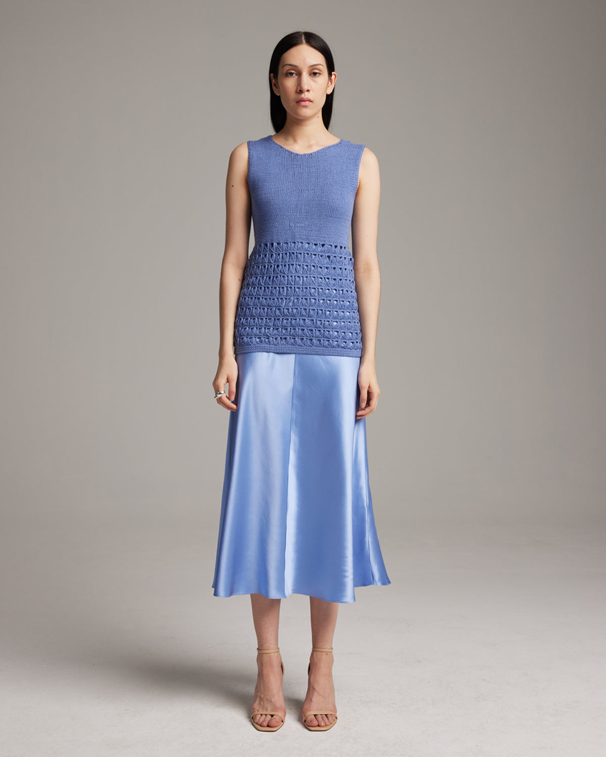 Model wearing a blue Pascuala Mesh Tunic with a satin skirt
