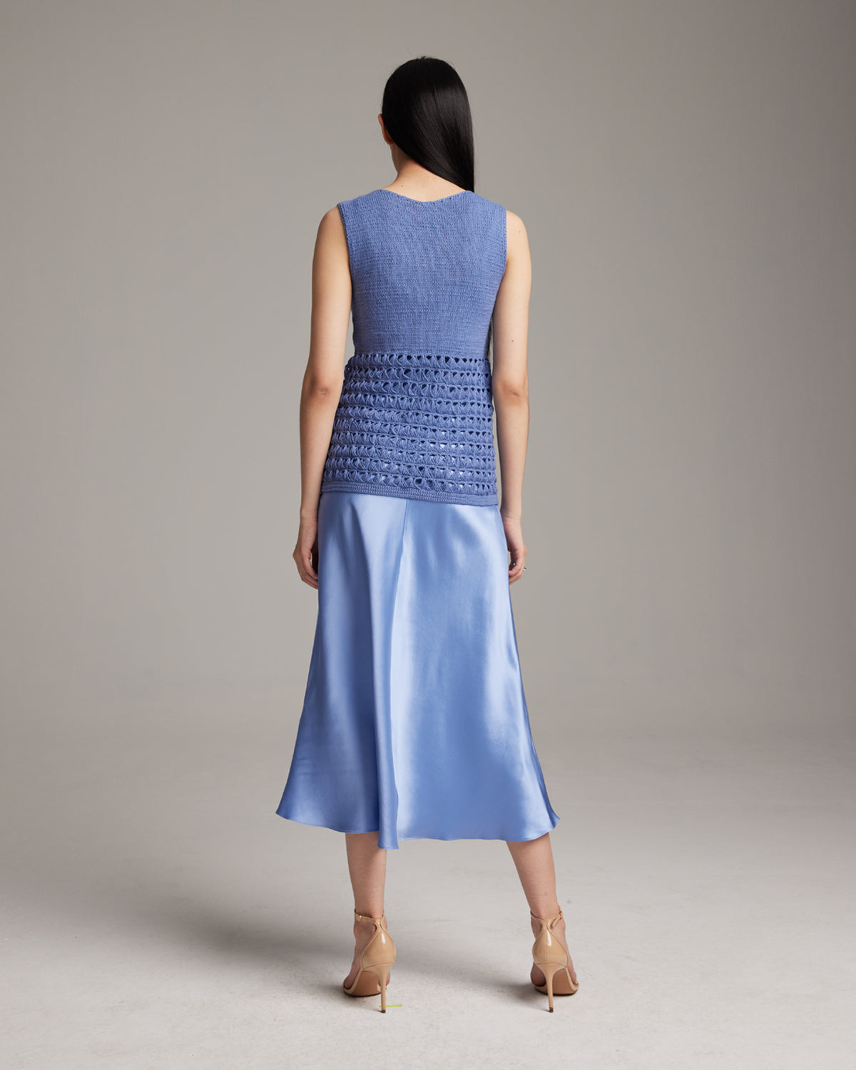 Back view of the Pascuala Mesh Tunic in cornflower blue, showcasing the hand-knit design.