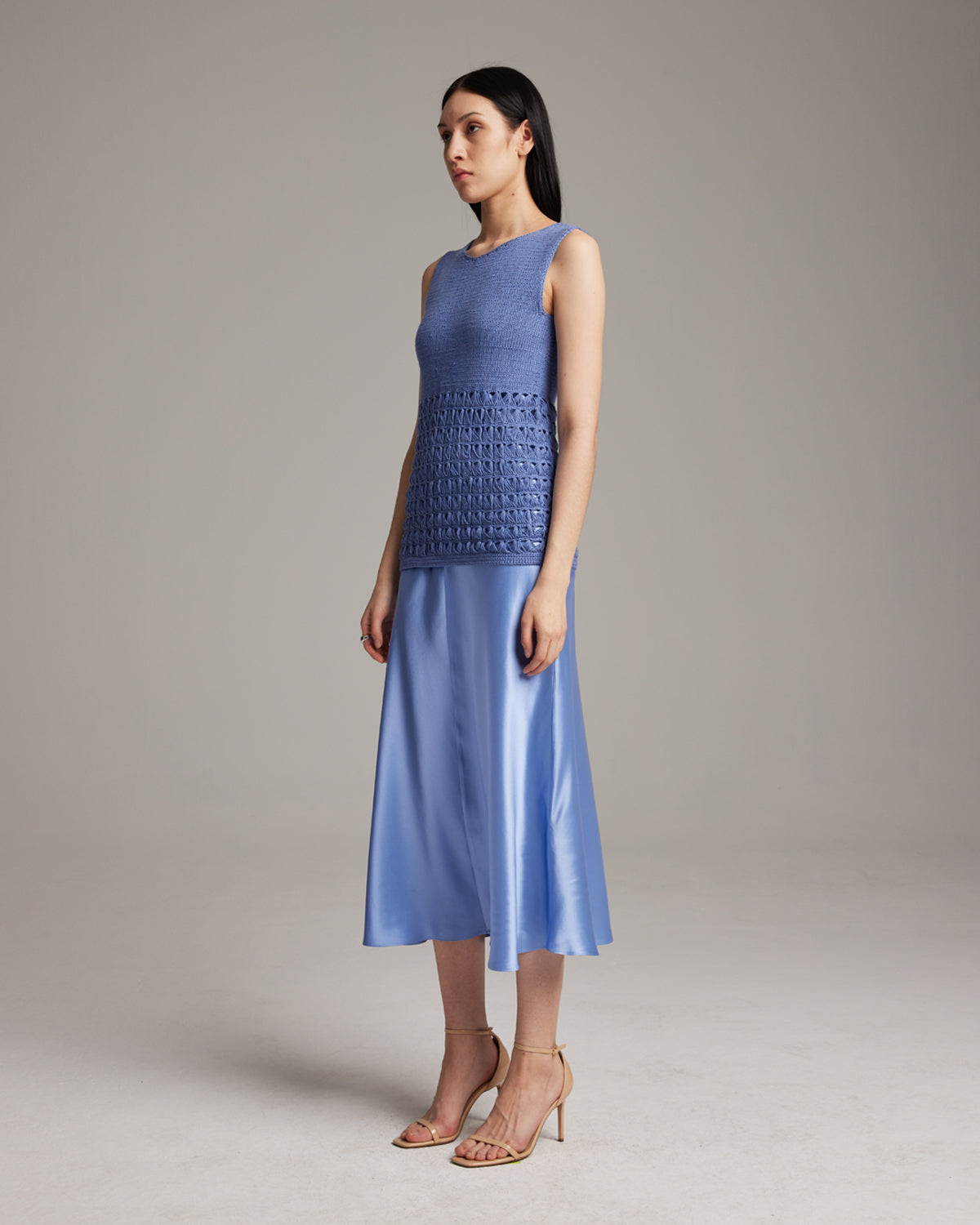 Model wearing a blue Pascuala Mesh Tunic with a flowing skirt