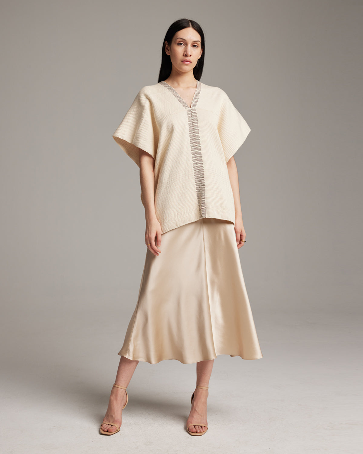 Model wearing Centro Lineas Manta top with a satin skirt
