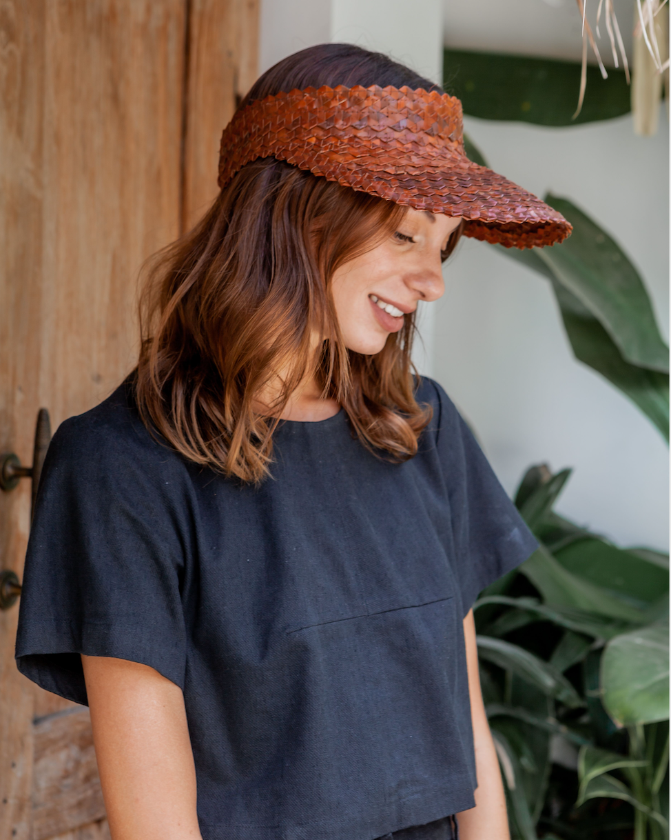 Rattan Sun Visor in Clay handmade by Village Thrive using natural materials.