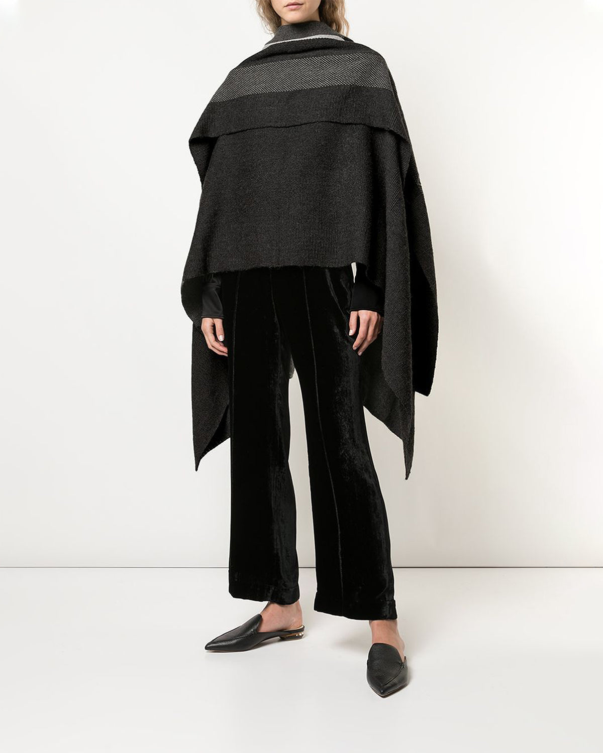 Model wearing a Wide Diagonal Alpaca Wrap in black, styled with black pants and shoes.