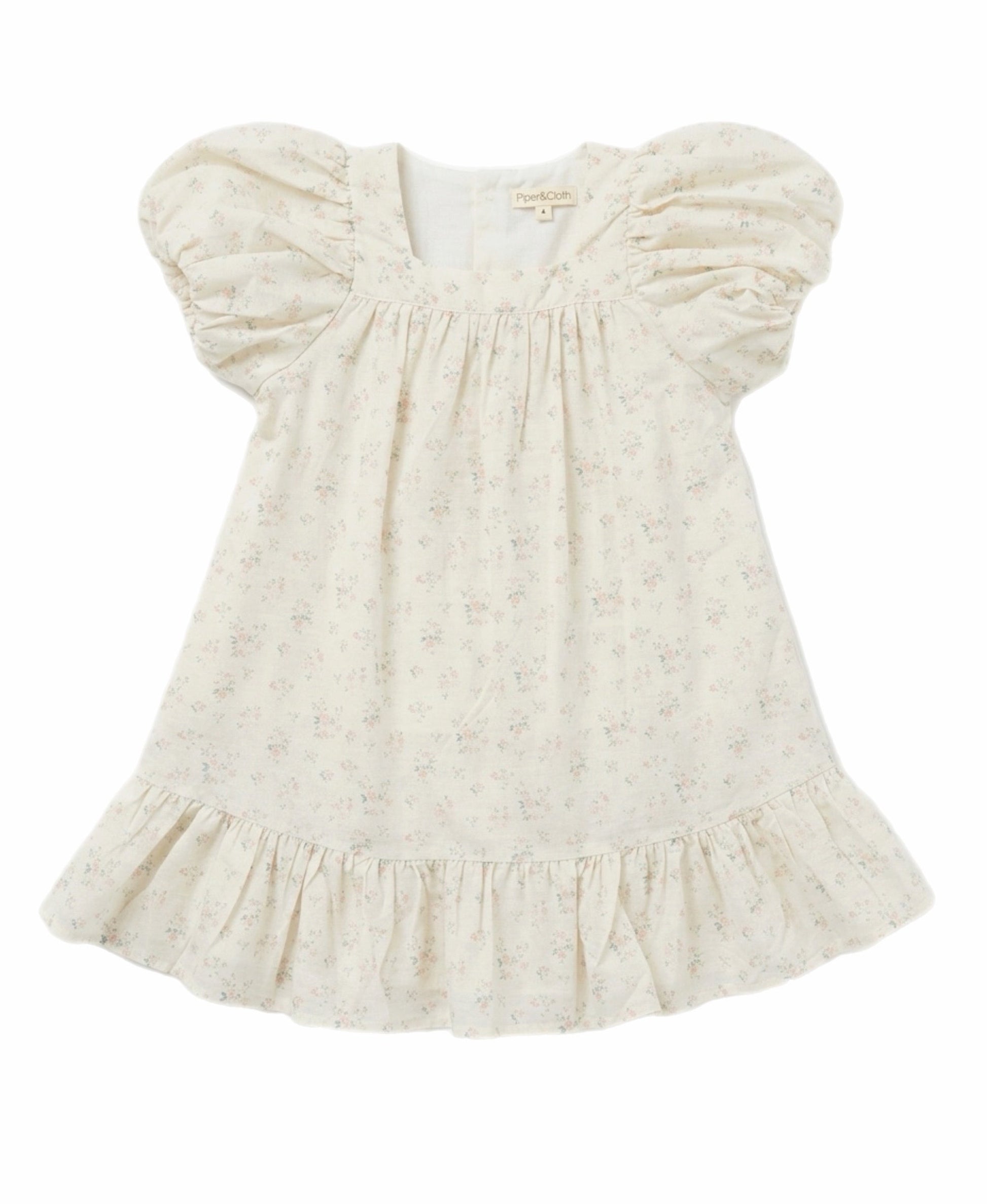 White baby dress with ruffled sleeves on a white background