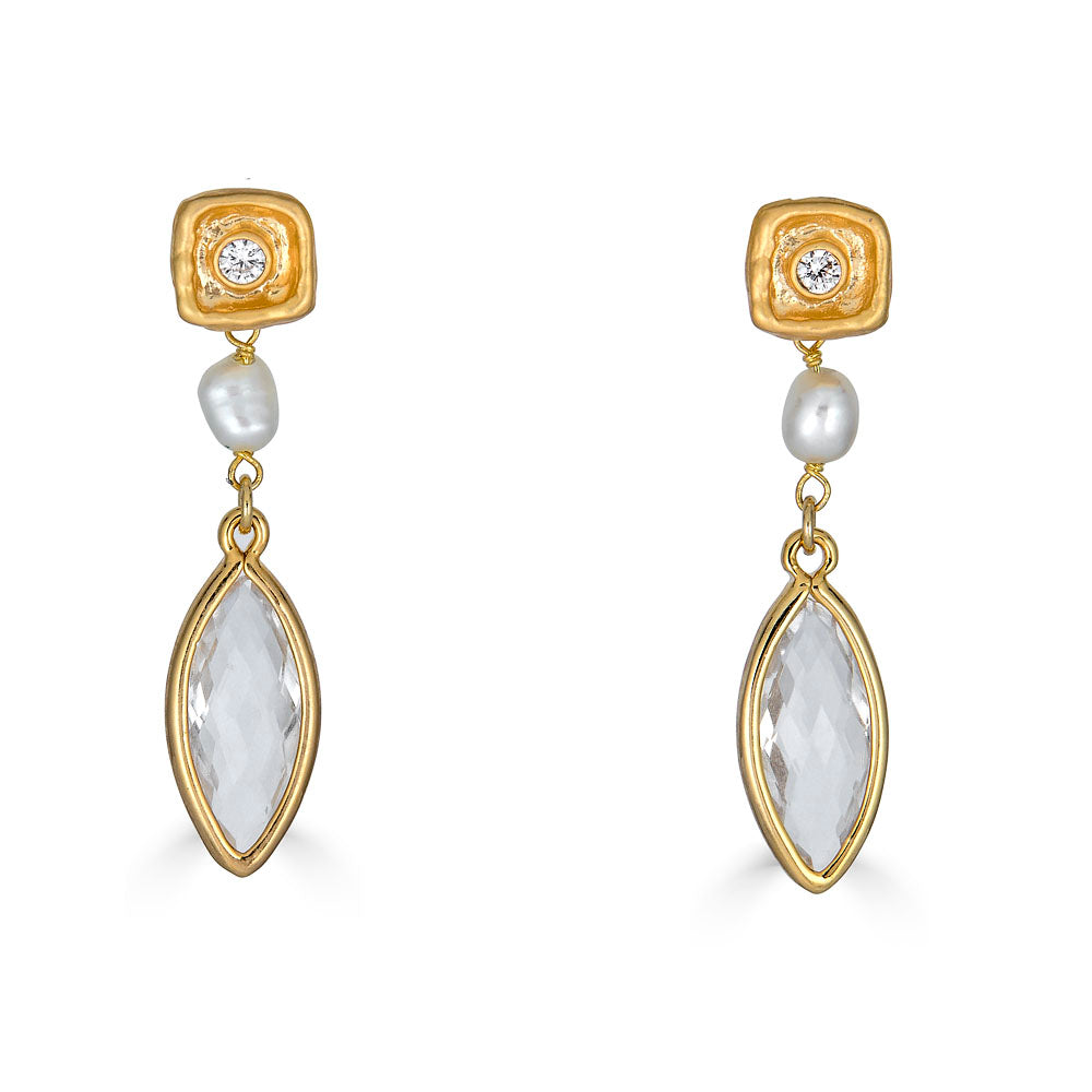Gold necklace with marquise crystal, spike charm, and smoky gem drop on a textured clasp